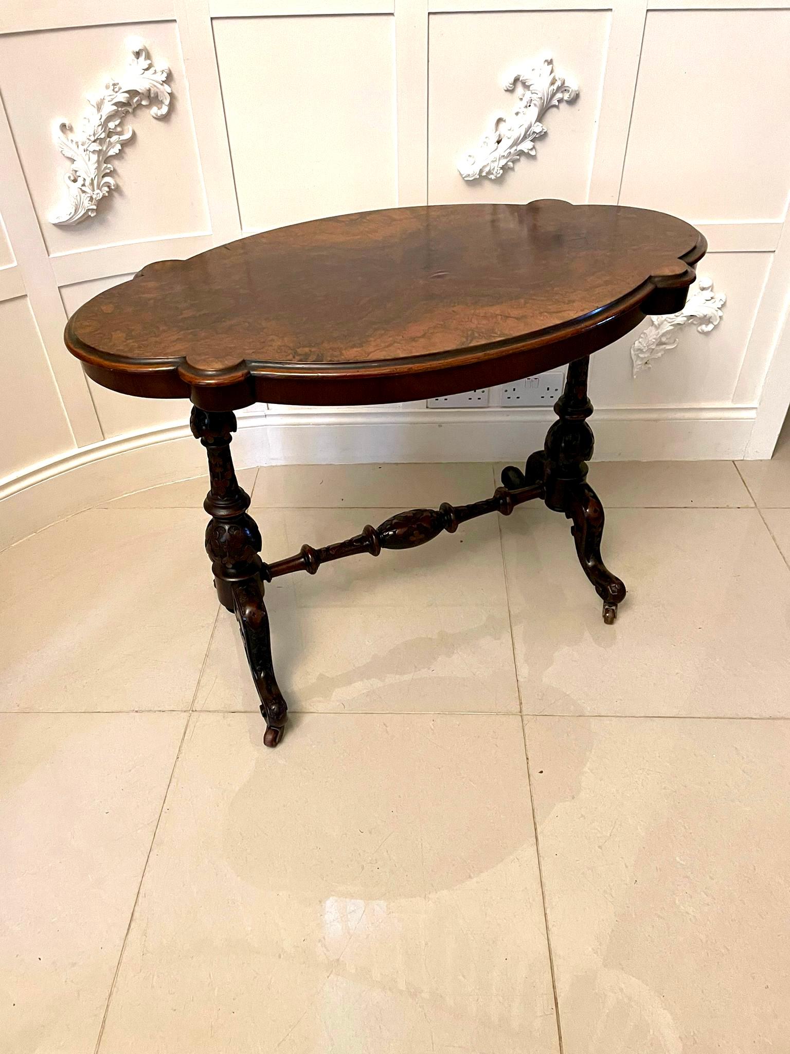 Antique Victorian quality burr walnut shaped centre table having a quality burr walnut serpentine shaped top with a thumb moulded edge, serpentine shaped frieze supported by quality solid carved walnut shaped columns and raised on shaped carved