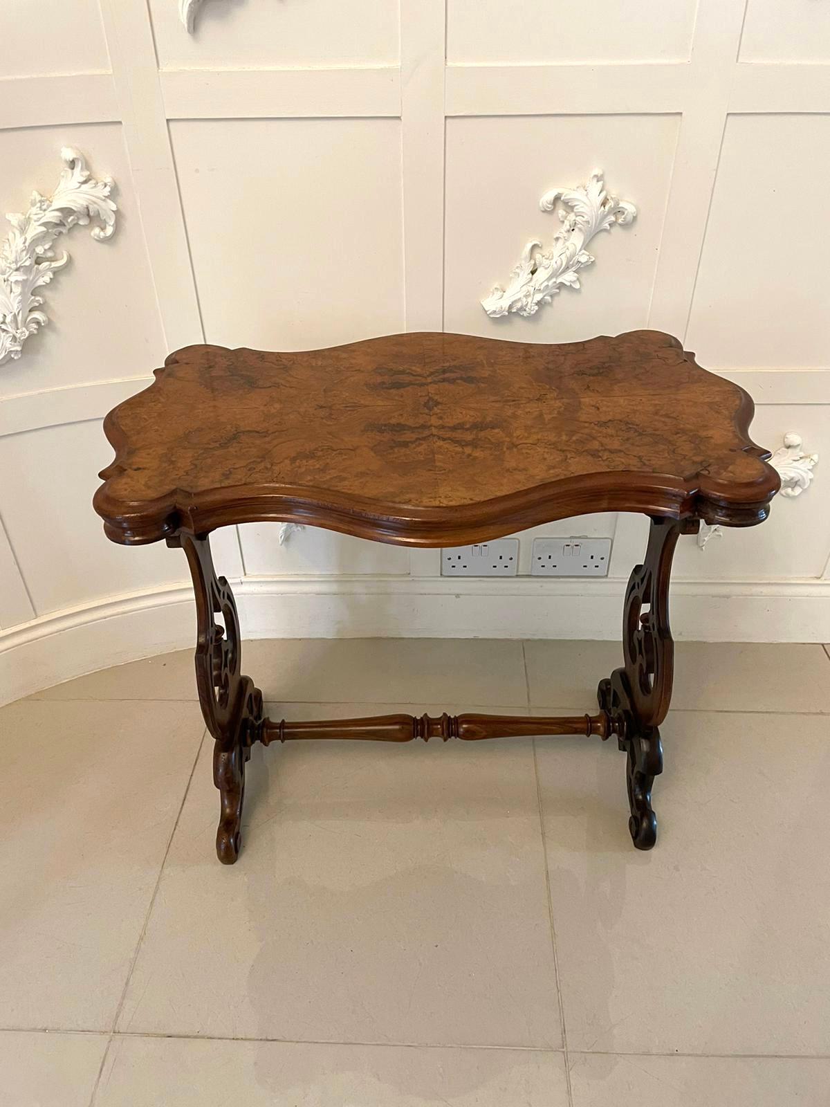 Antique Victorian quality burr walnut shaped centre table having a quality burr walnut serpentine shaped top with a moulded edge, serpentine shaped frieze supported by a solid walnut shaped carved supports raised on shaped carved solid walnut