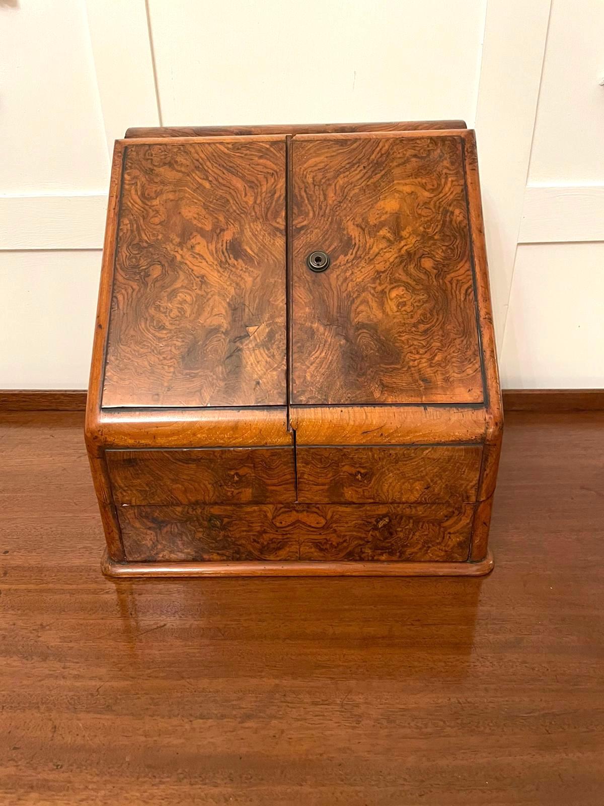 Antique Victorian quality burr walnut stationery box having quality burr walnut doors opening to reveal a fitted interior consisting of a calandra, pair of original ink wells, letter rack, notepad and a burr walnut drawer.

Measures: H 32cm 
W