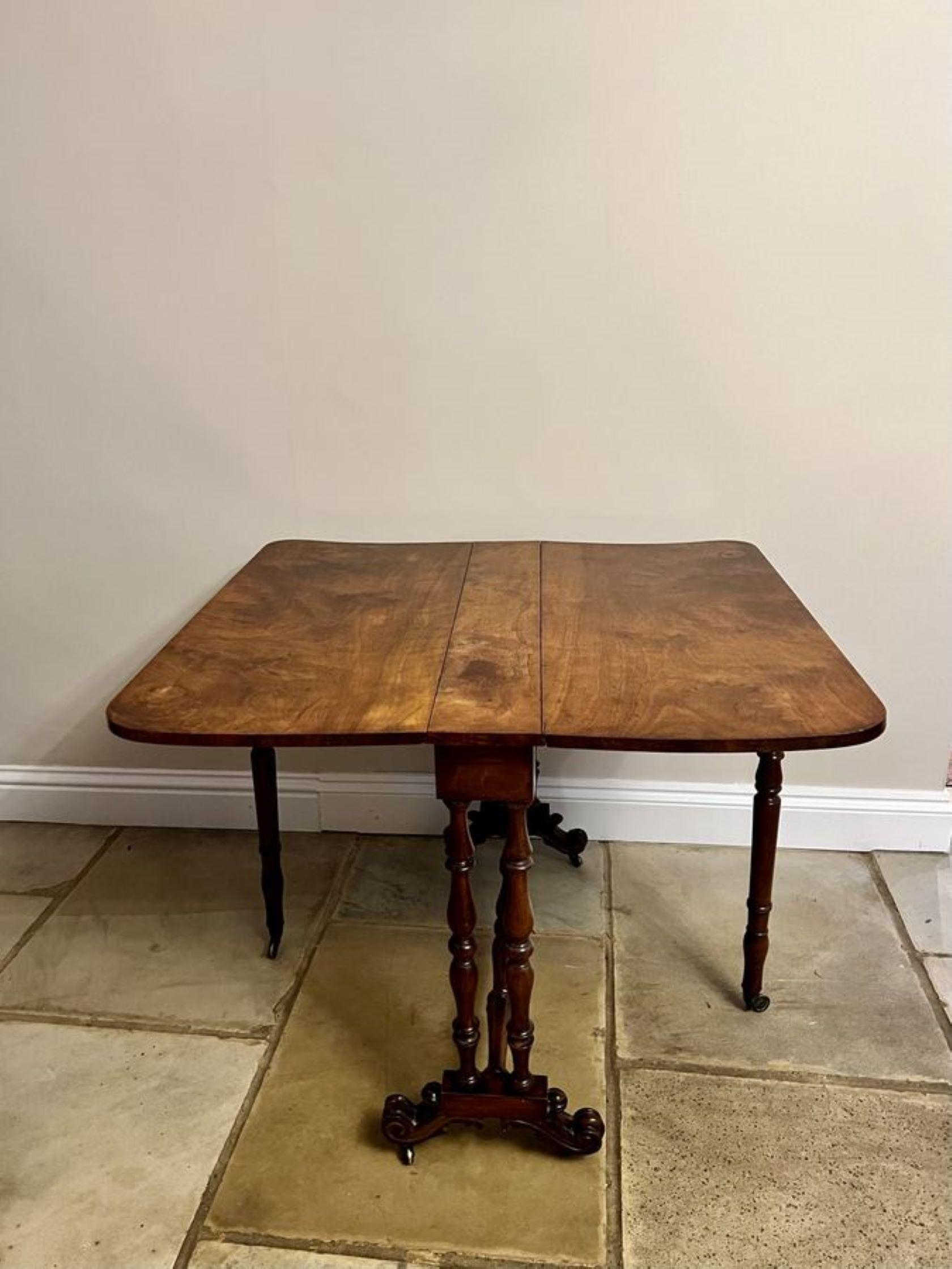 Antique Victorian quality burr walnut Sutherland table having a quality burr walnut top with two drop leaves supported by two gate legs, turned walnut column and supports standing on scroll feet united by a turned walnut stretcher. 
Width open
