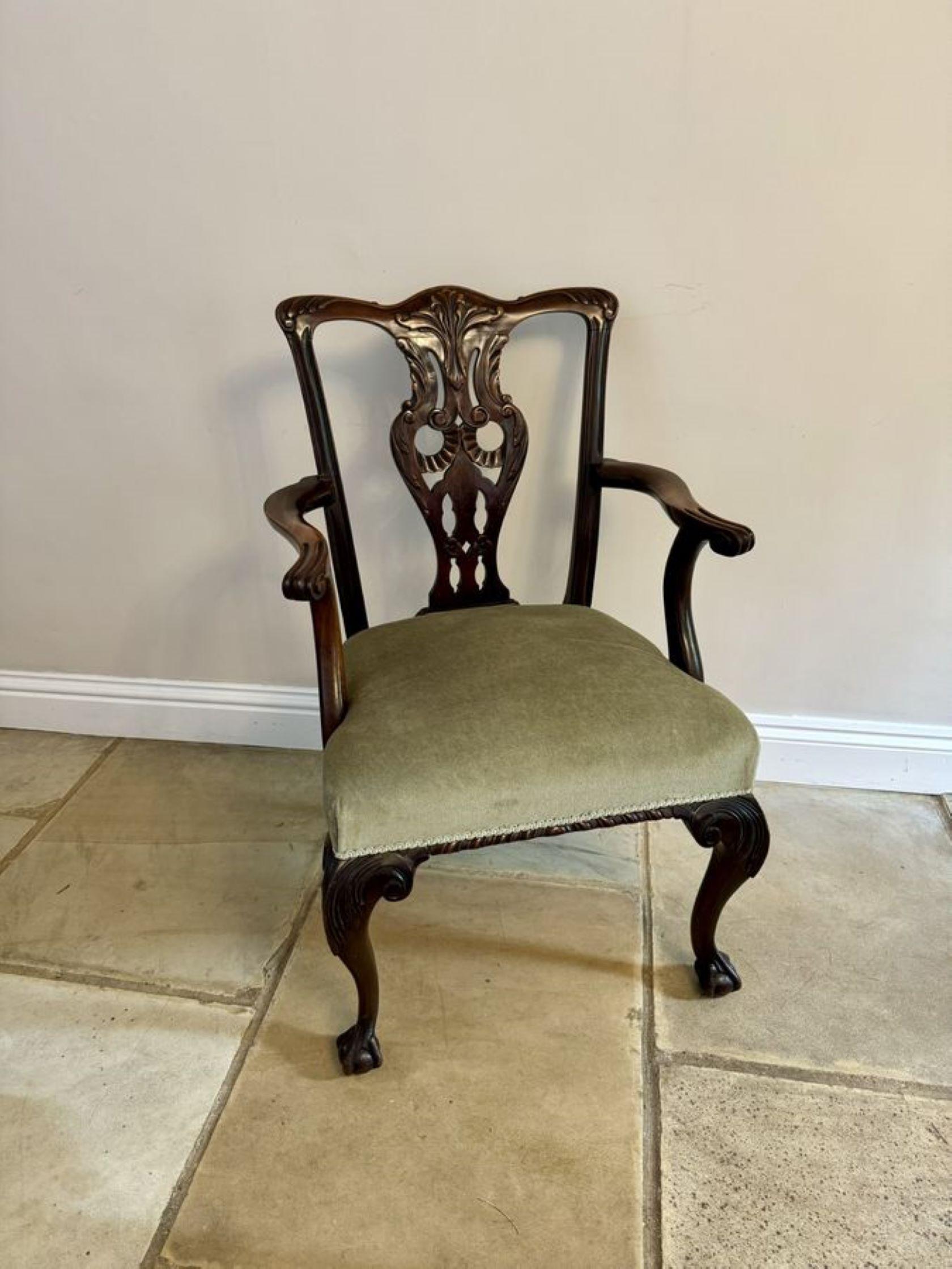 Antique Victorian quality carved mahogany desk chair, having a quality carved mahogany back, shaped open arms with carved scrolls, upholstered seat standing on shaped carved cabriole legs with claw and ball feet to the front and out swept back