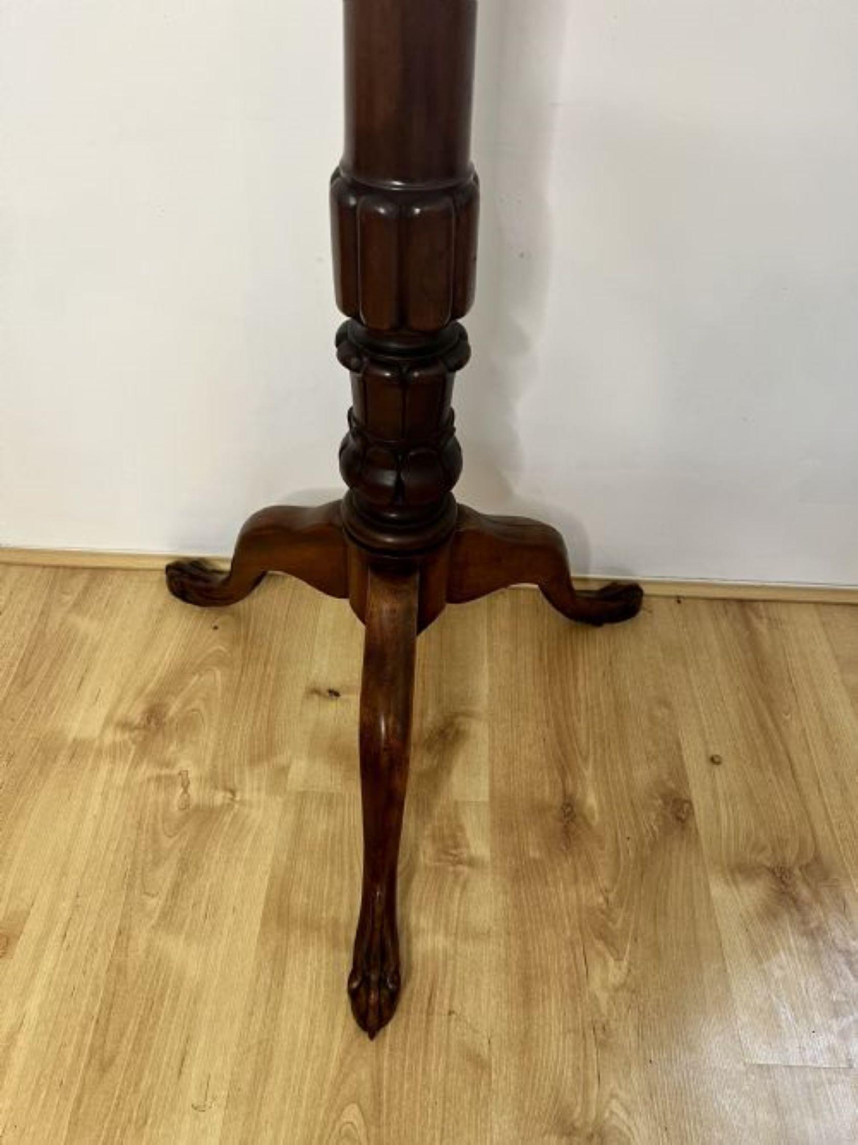 Antique Victorian quality carved mahogany torchere having a circular mahogany top with a moulded edge supported by a turned carved tapering quality mahogany column standing on three shaped cabriole legs with claw feet.