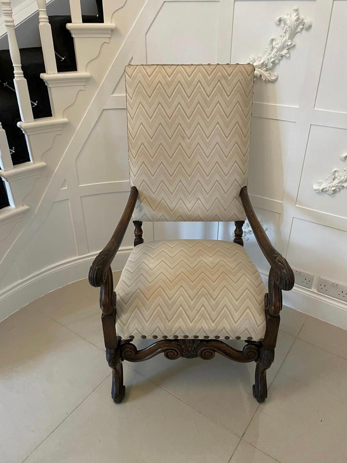 Antique Victorian quality carved oak armchair having an upholstered back and seat in a quality fabric, carved oak shaped open arms standing on shaped carved cabriole legs with scroll feet to the front united by a quality carved scroll shaped