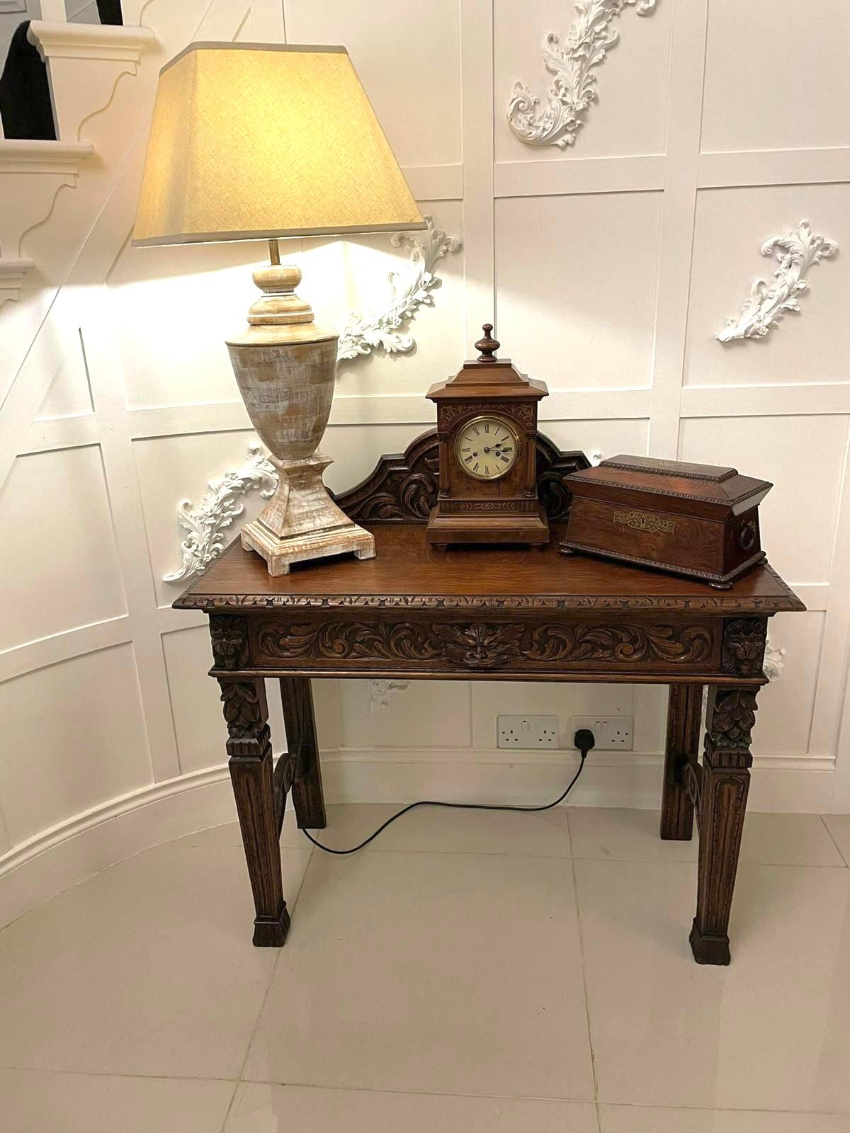 Antique Victorian quality carved oak side table having a quality carved oak shaped back above an oak top with a carved edge, one long carved oak drawer to the front and standing on four carved oak tapering legs with block feet united by shaped
