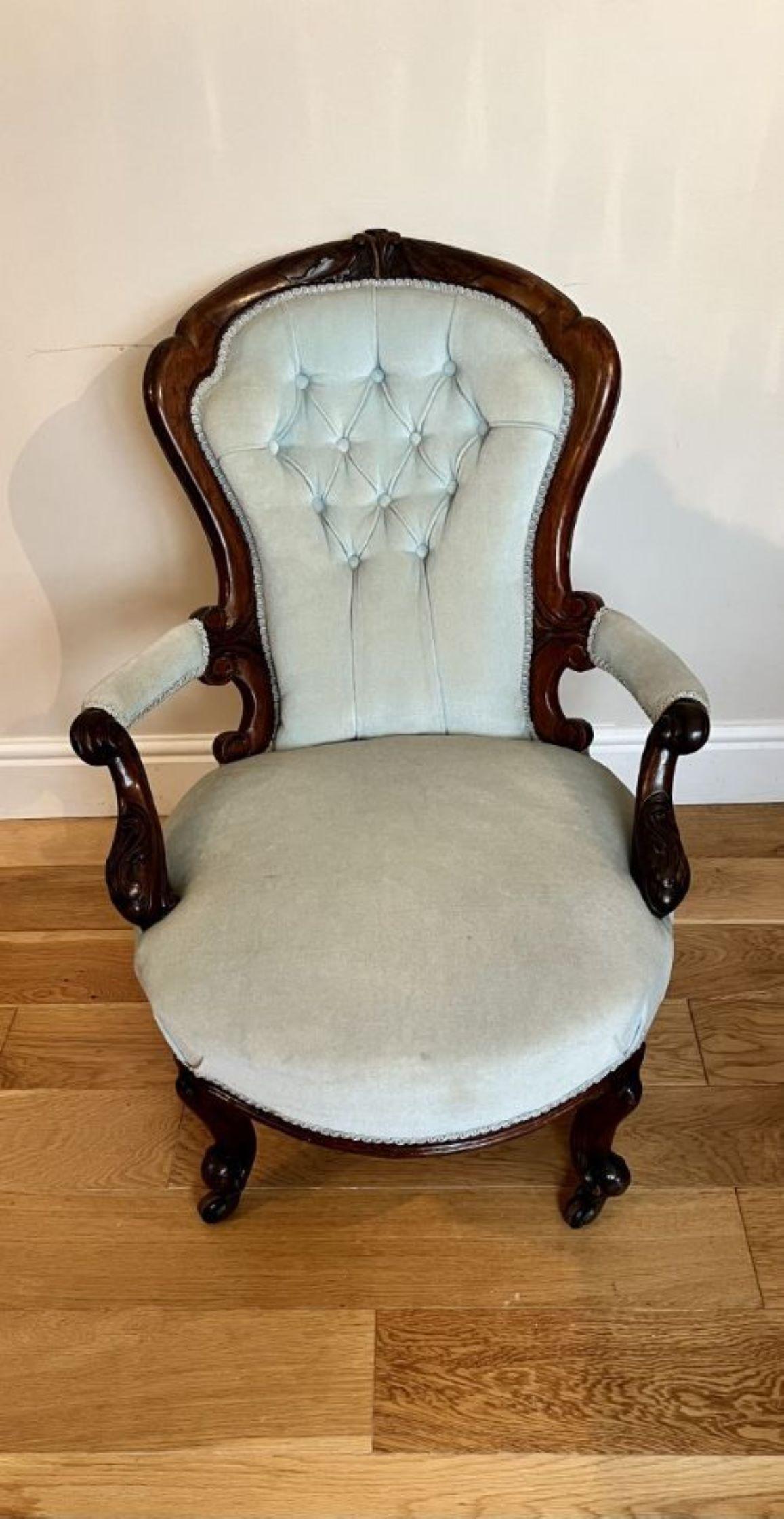 Antique Victorian quality carved walnut arm chair having a quality carved walnut shaped back, carved walnut shaped open arms standing on shaped carved cabriole legs with scroll feet, out swept back legs with the original casters 