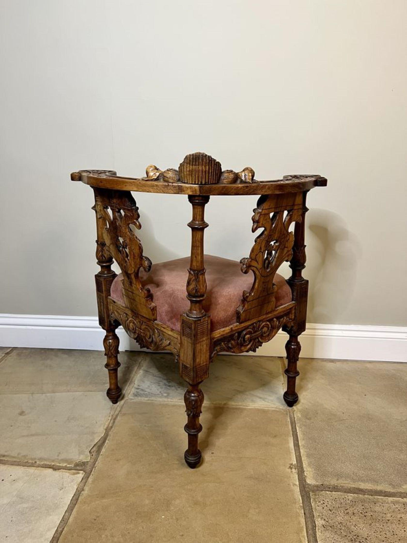 Antique Victorian quality carved walnut Italian corner chair having a quality carved solid walnut shaped back with a cherub to the centre griffins and dragons pierced carved splats, turned carved column supports, a drop in seat, shaped carved solid