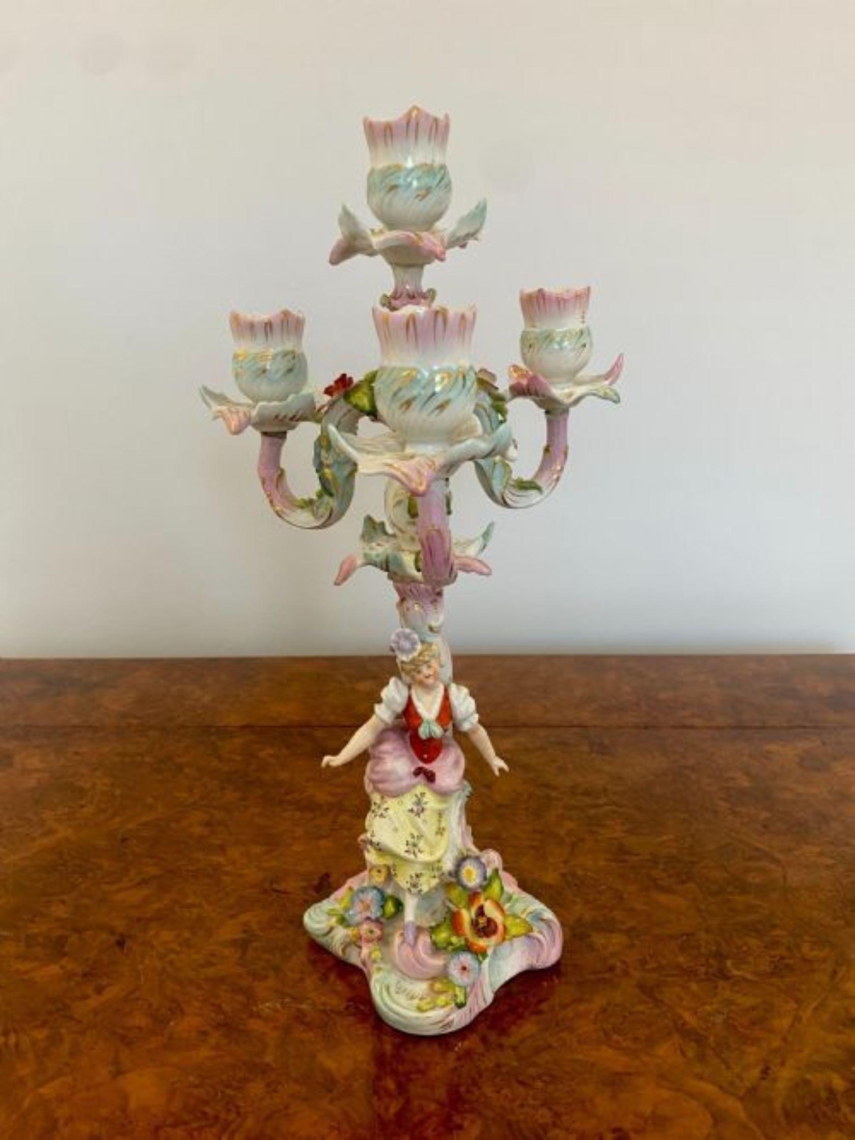 Antique Victorian quality continental porcelain candelabra having a quality four branch candelabra above a seated lady in wonderful period clothing with lovely hand painted flowers and leaves decorated in red, blue, white, green and pink colours. 