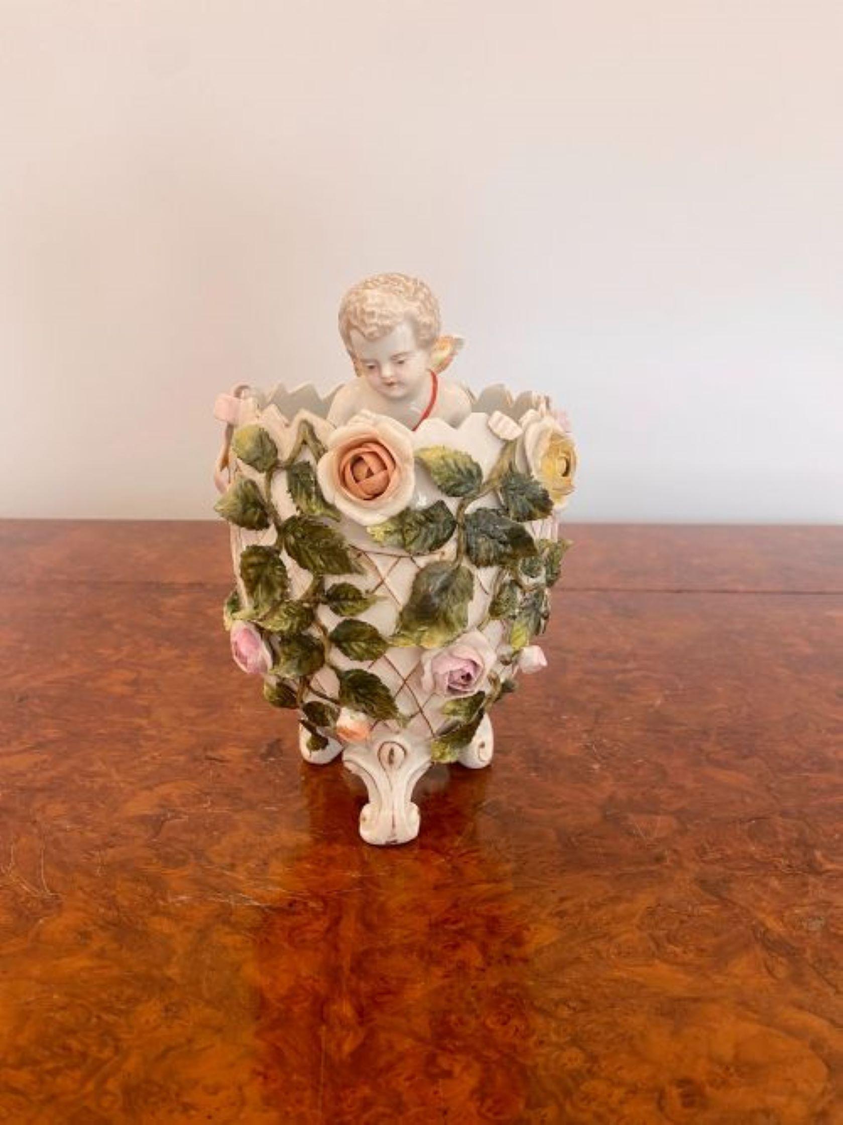 Antique Victorian quality continental porcelain cherub in a vase decorated with leaves and flowers in wonderful green, yellow, pink and orange colours raised on scroll feet