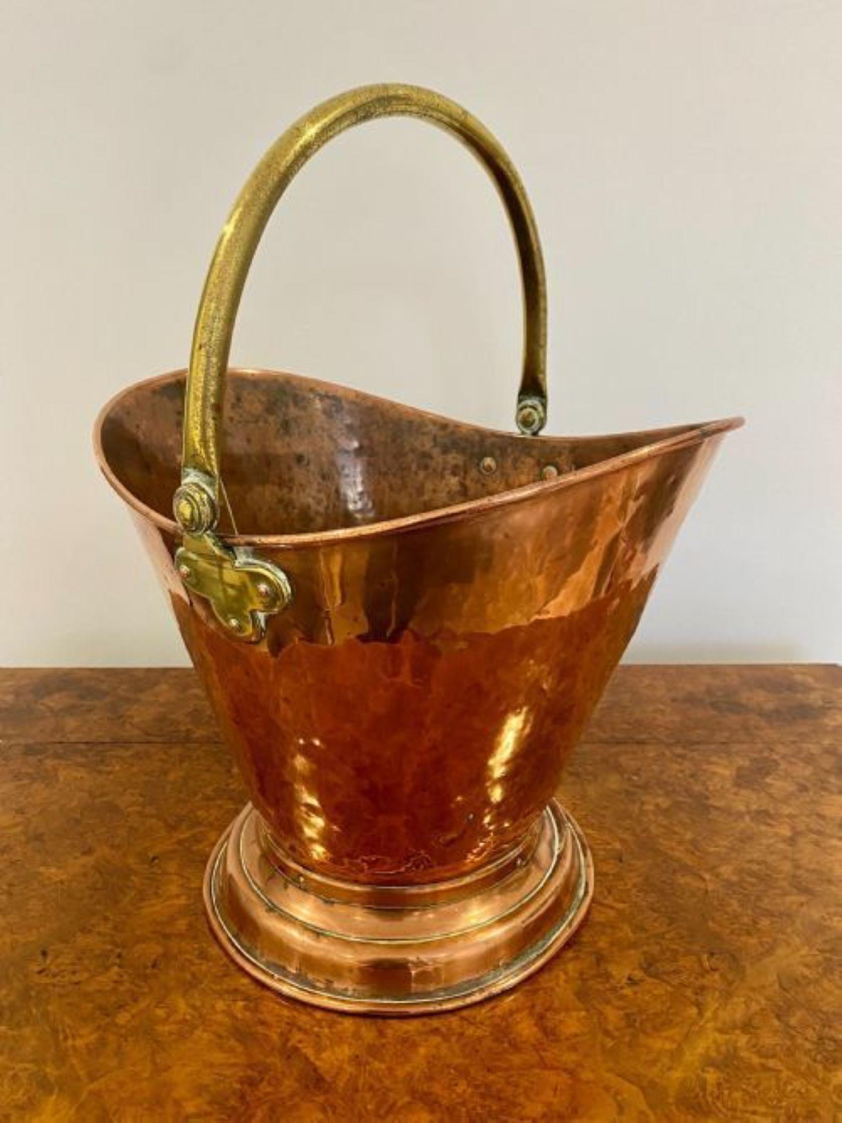 Antique Victorian quality copper and brass helmet coal bucket.
Quality copper helmet coal bucket coal bucket raised on a circular stepped base with a brass swing handle 