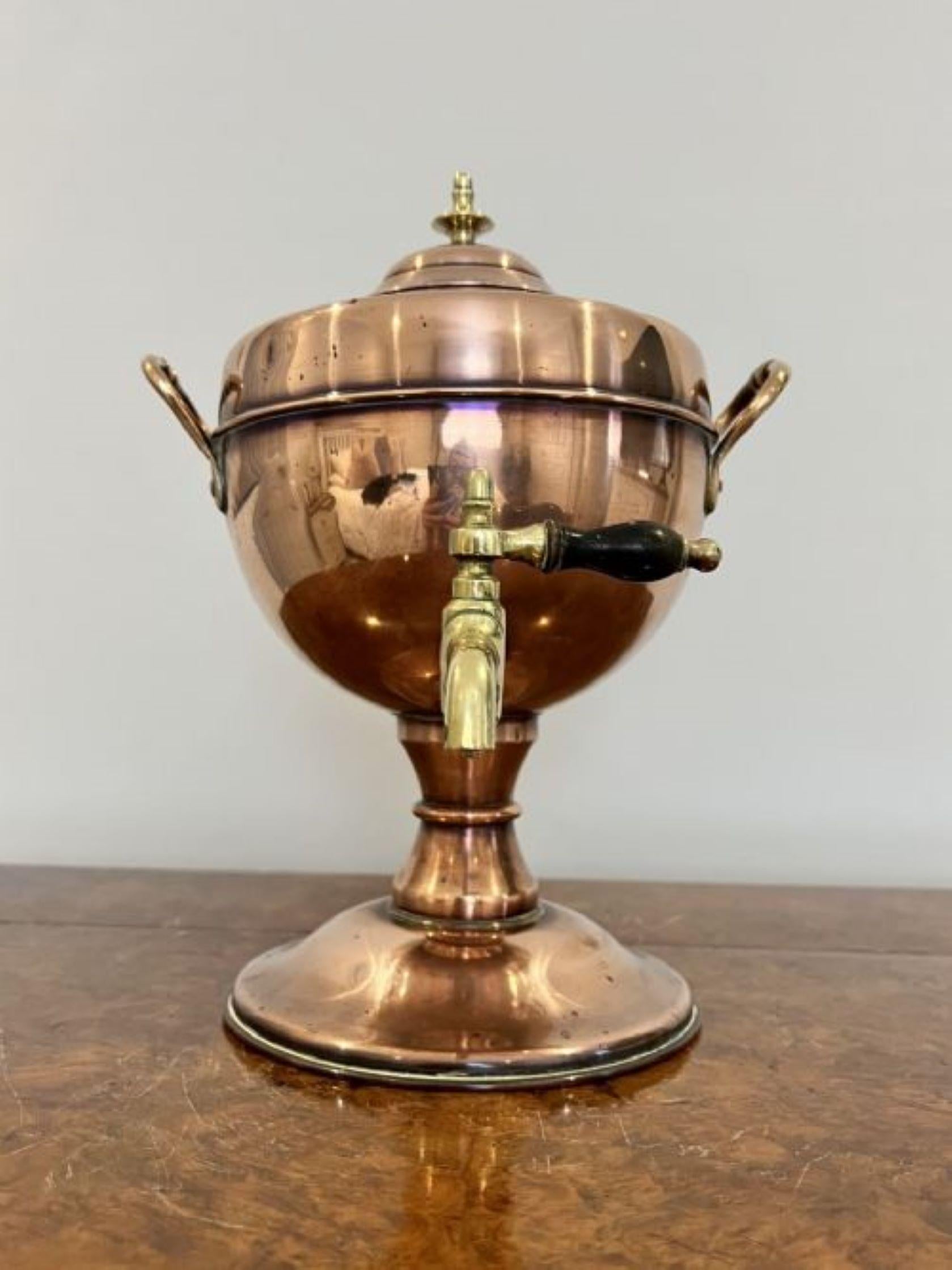 Antique victorian quality copper and brass tea urn having a lift off lid with a brass finale to the top, shaped body with the original brass tap standing on a circular base 
