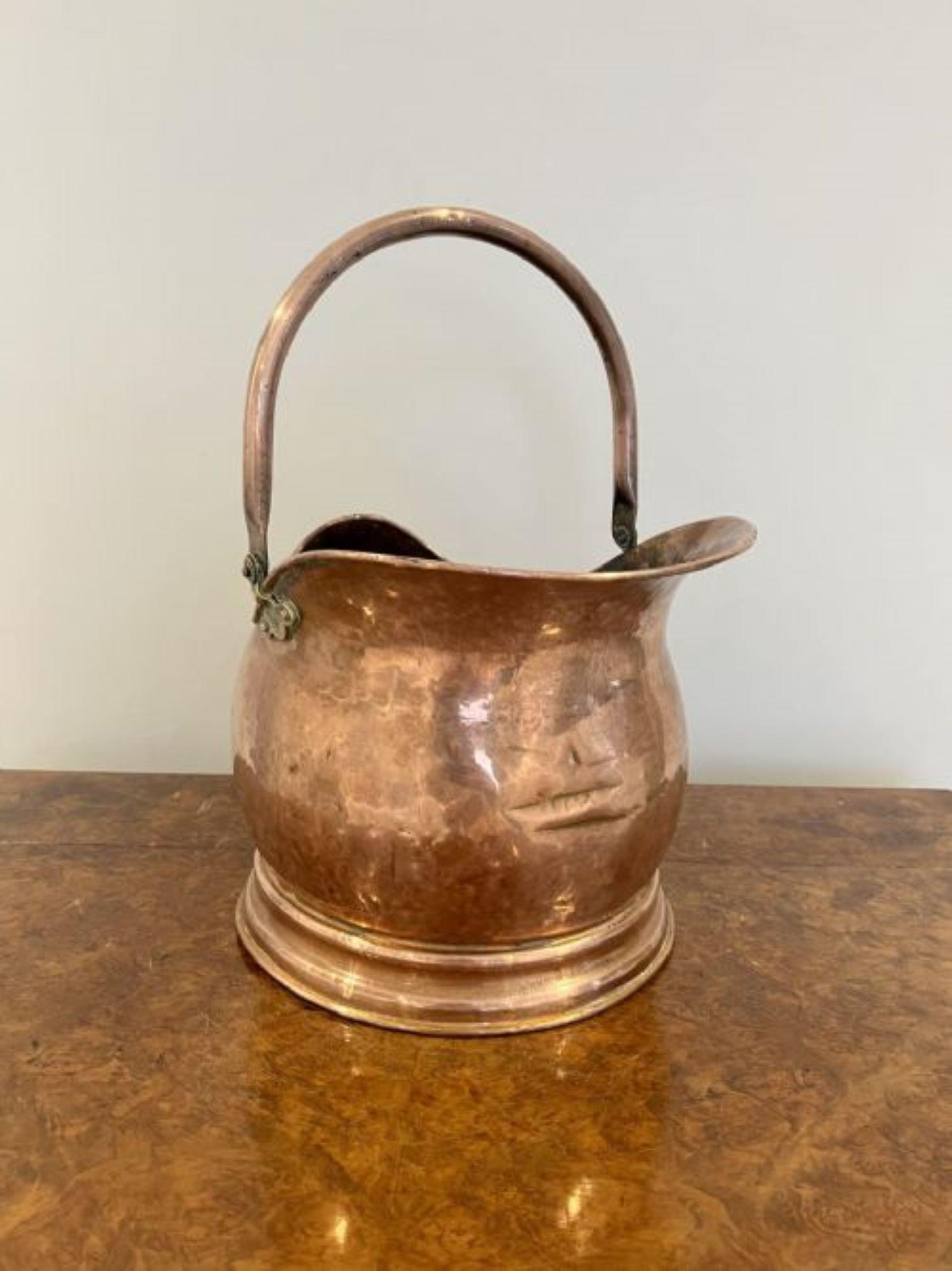 Antique Victorian quality copper helmet coal scuttle having a shaped carrying handle with a shaped quality copper helmet coal scuttle and a brass handle to the back 
