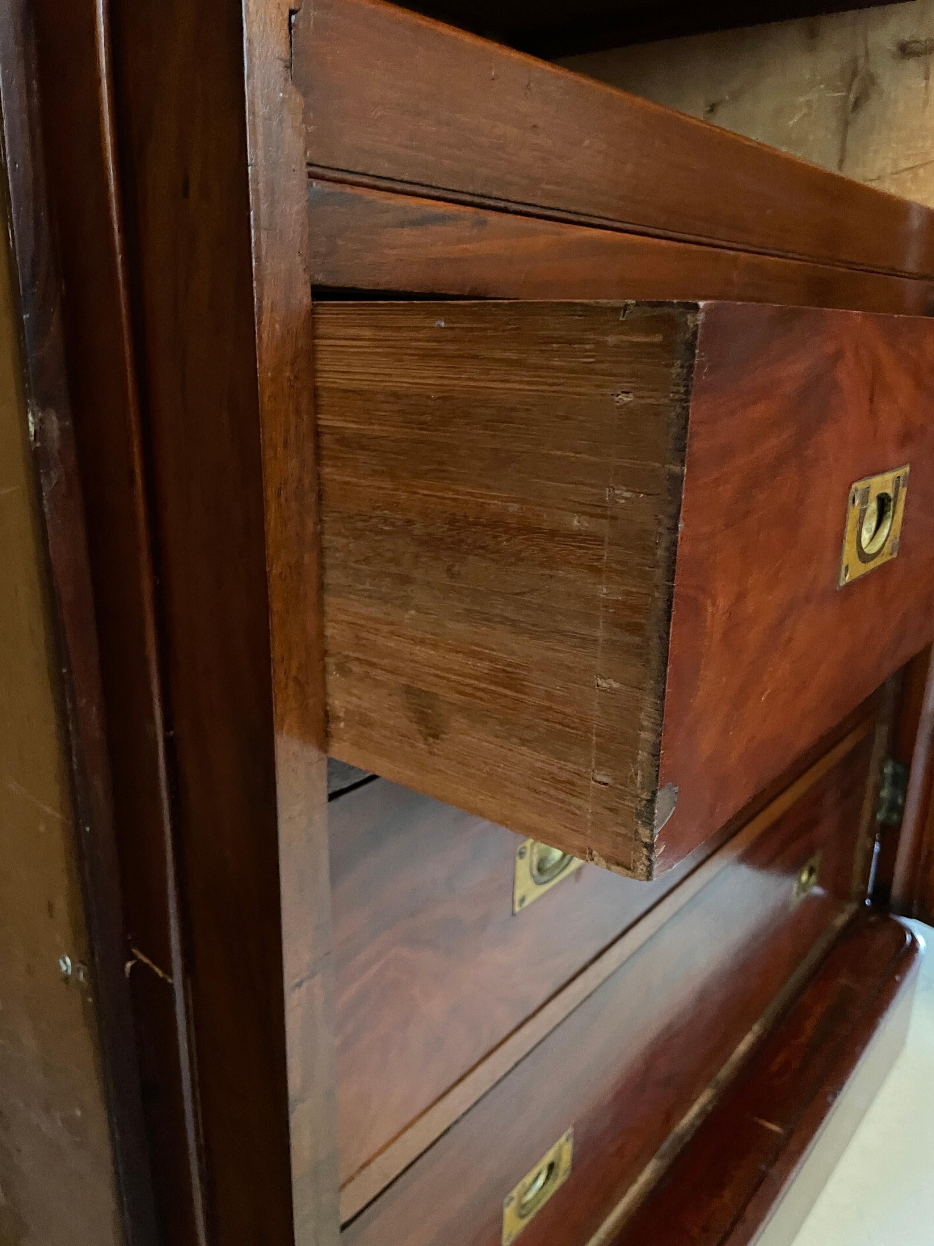 Antique Victorian quality figured mahogany breakfront wardrobe having a quality figured mahogany shaped cornice above a large shaped mirror door opening to reveal a fitted interior consisting of 4 sliding trays and 3 long drawers with original brass
