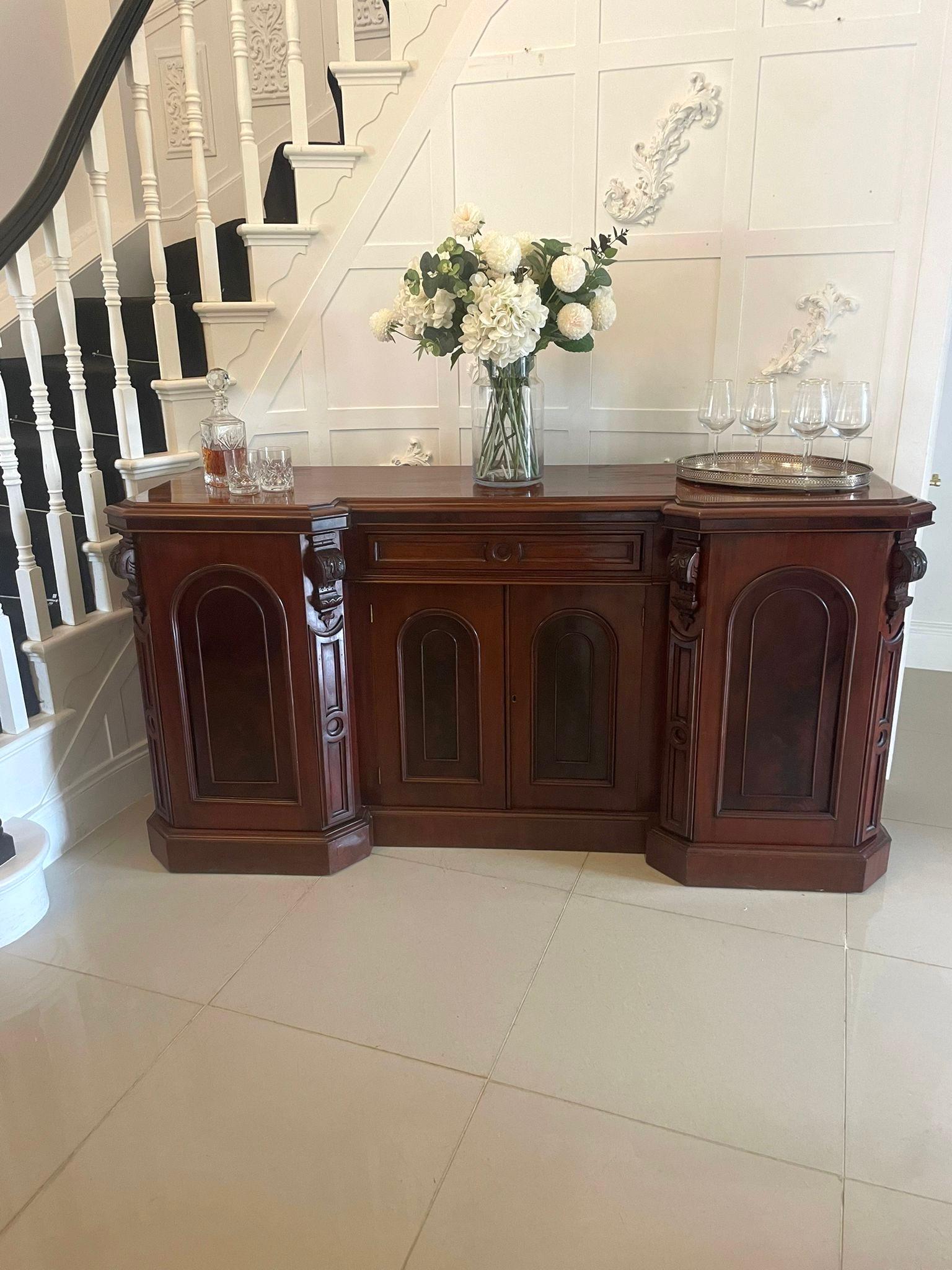 Antique Victorian quality figured mahogany four door sideboard having a quality figured mahogany top with a double moulded edge above a single drawer to the centre, four figured mahogany moulded panelled doors opening to reveal sliding trays,