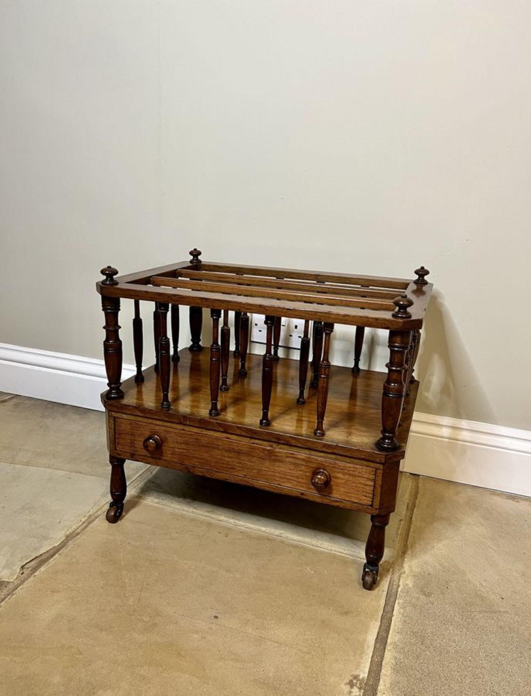 Antique Victorian quality figured walnut Canterbury having turned finals above three sections with turned supports, a single drawer to the front with the original walnut knobs standing on turned feet with the original castors. 

D. 1870
