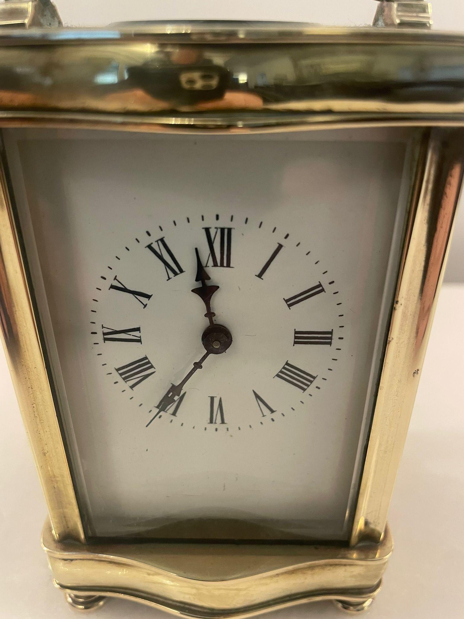 Antique Victorian quality French carriage clock with the original carrying case having a quality serpentine shaped brass case with a swing handle to the top, bevel edge glass panels, white enamel dial with original hands, 8 day french movement,