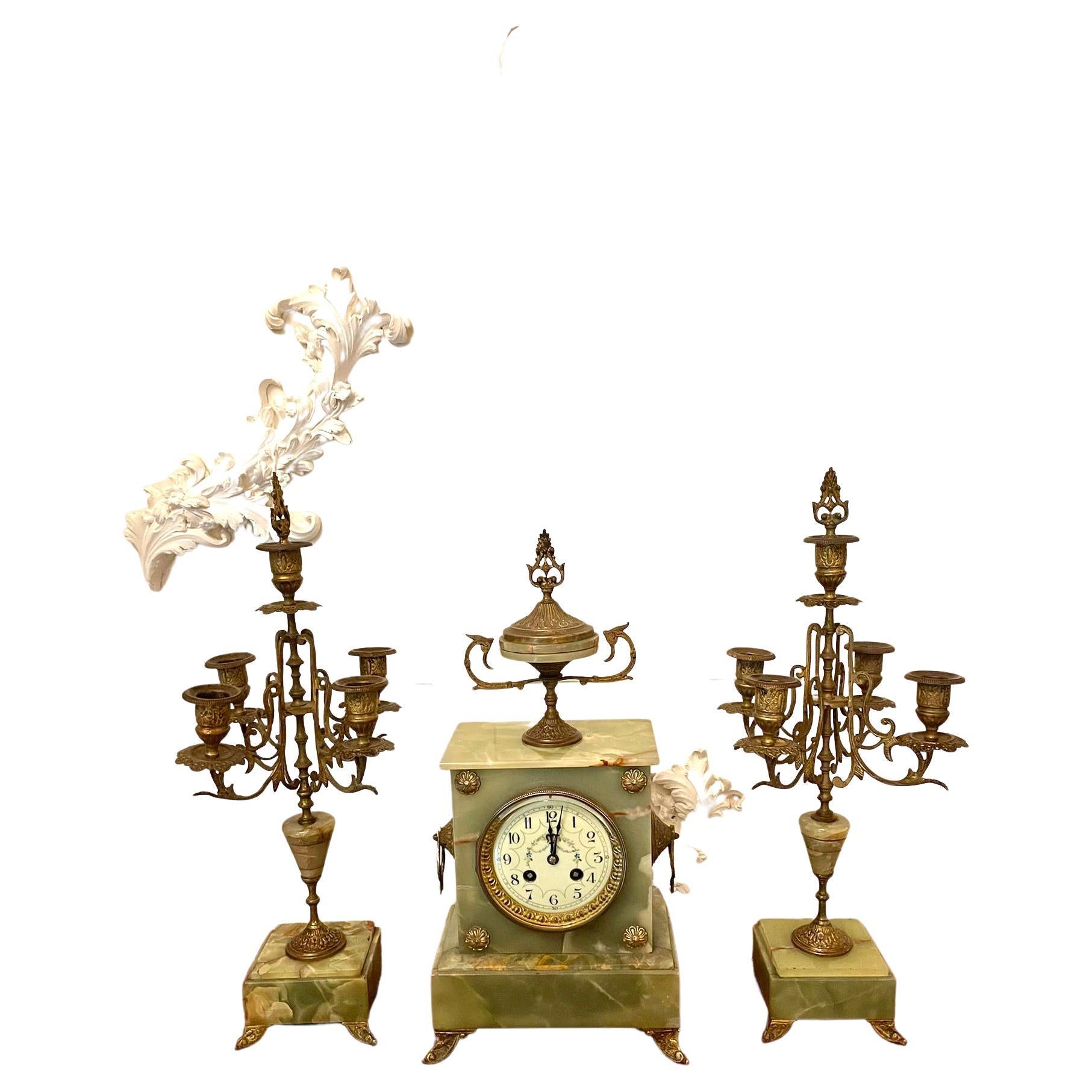 Antique Victorian quality green onyx ornate clock garniture having a quality circular floral decorated dial with original hands, eight day movement striking the hour and half hour on a bell. The case is surmounted by an urn with carrying handles to
