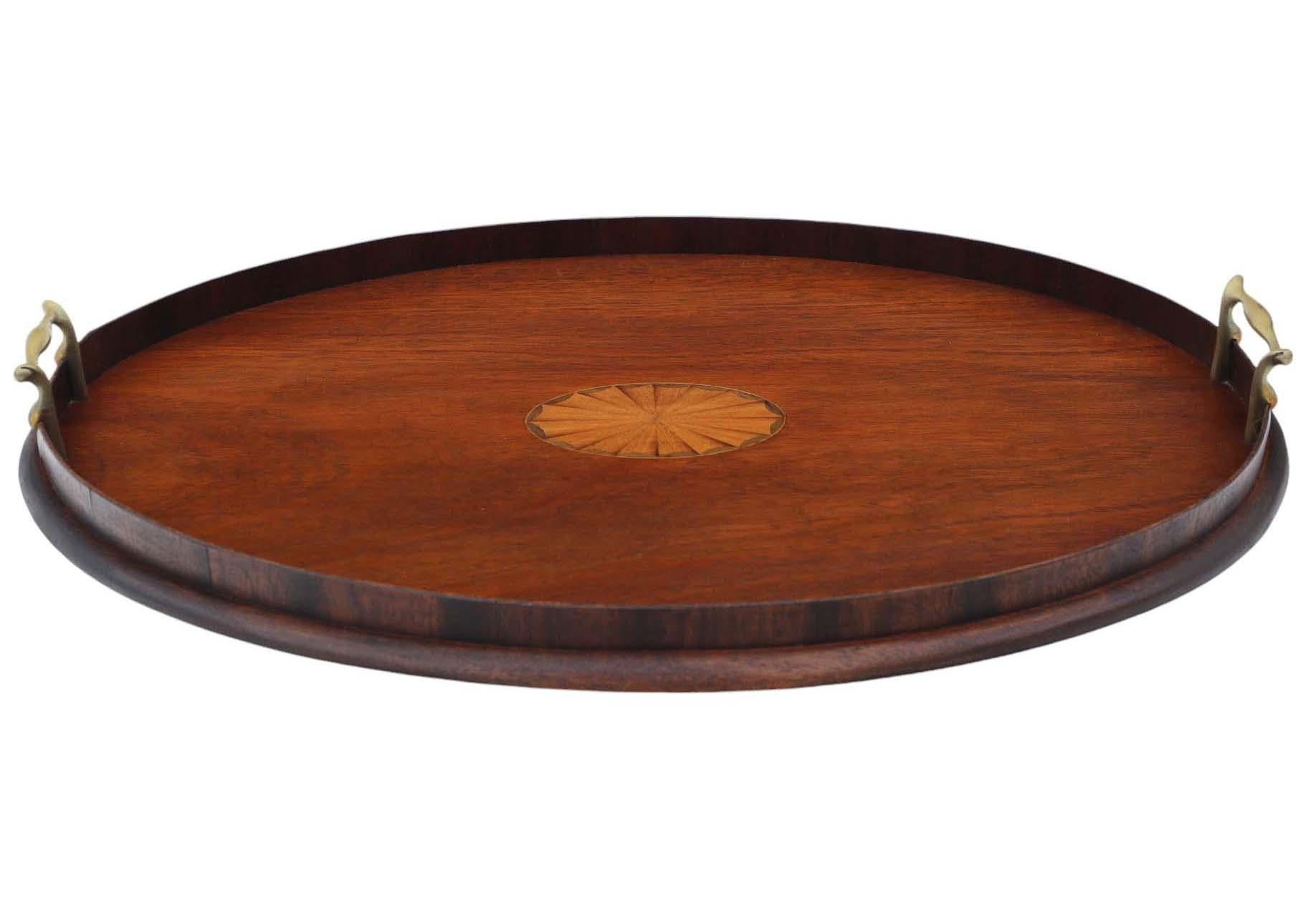 Antique Victorian quality inlaid mahogany oval serving tray tea C1900.

A great quality tray with a wooden gallery and brass handles.

Very attractive, with lovely proportions and styling.

Desirable oval shape, with decorative marquetry