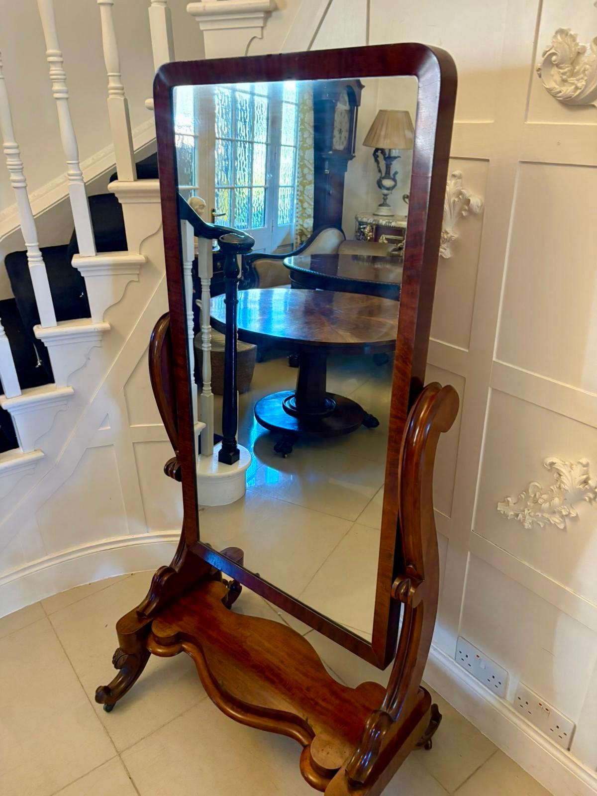 Antique Victorian quality mahogany cheval mirror having the original adjustable mirror in a quality mahogany frame supported by two large scroll supports standing on shaped cabriole legs with scroll feet, original castors united by a serpentine