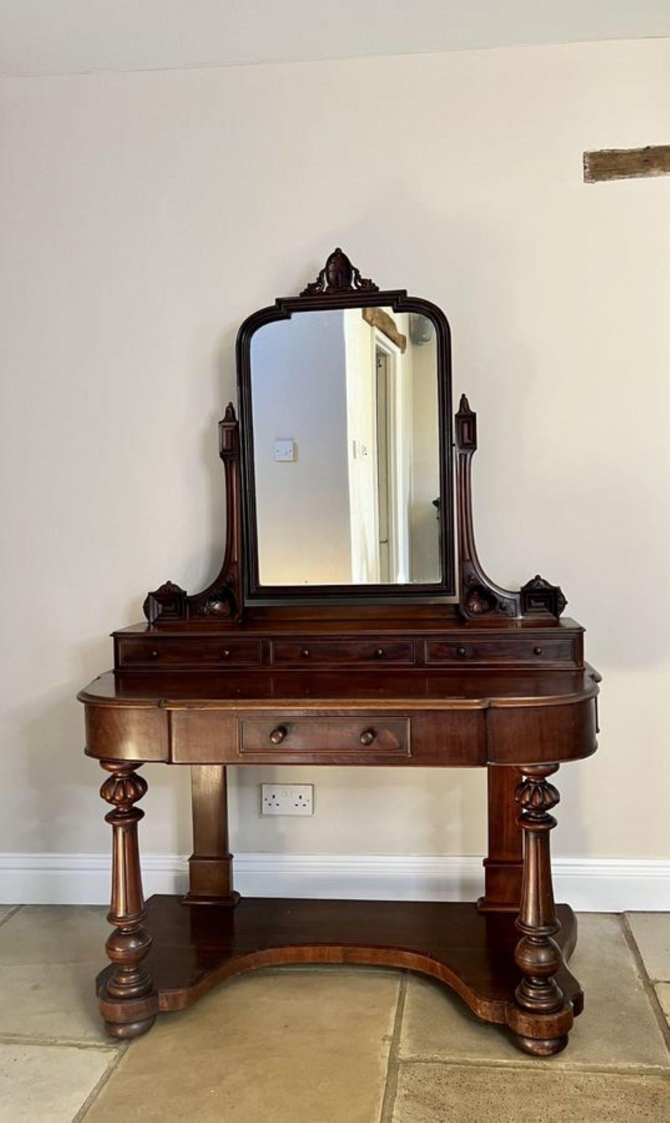 Antique Victorian quality mahogany duchess dressing table having a tilting mirror supported by quality carved mahogany arms above three drawers with original turned mahogany knobs, above a mahogany top with a thumb moulded edge, a single drawer to