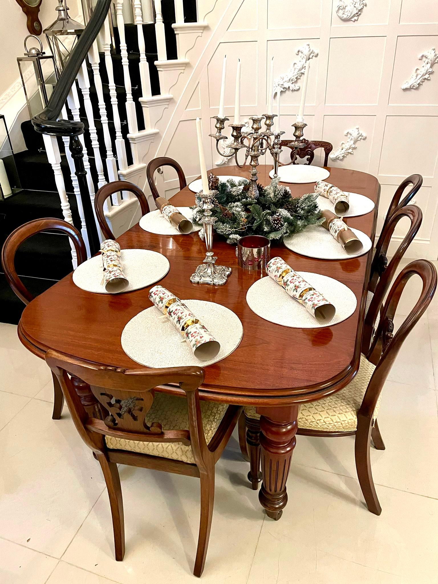Antique Victorian quality mahogany extending dining table having a quality D end shaped top with a double moulded edge and two original extra leaves, original winding mechanism and handle and standing on four mahogany turned reeded tapering legs