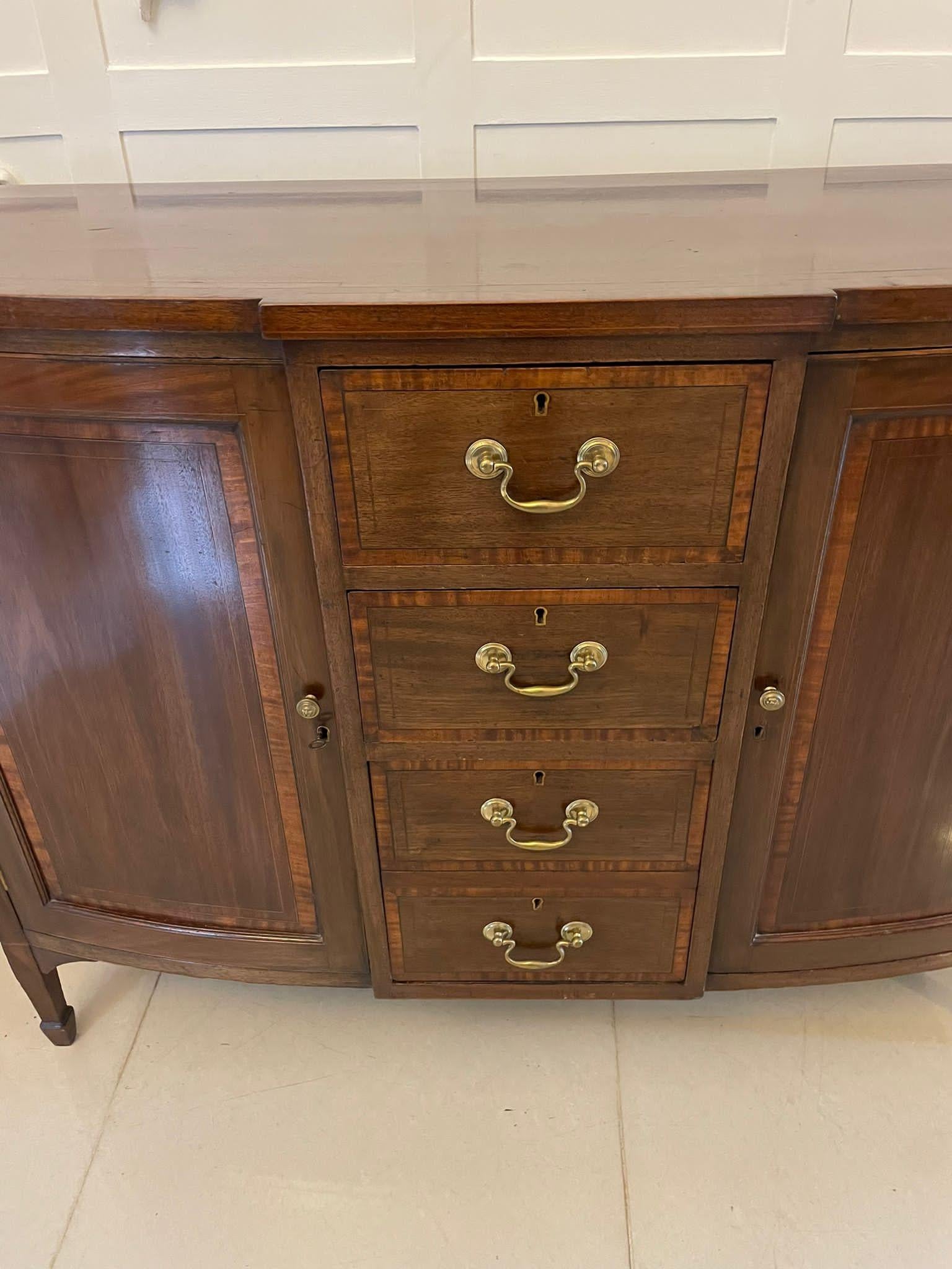 Antique Victorian quality mahogany inlaid sideboard by Edwards and Roberts having a quality mahogany shaped top crossbanded in satinwood above three drawers crossbanded in satinwood with original brass swan neck handles,  one drawer stamped Edwards