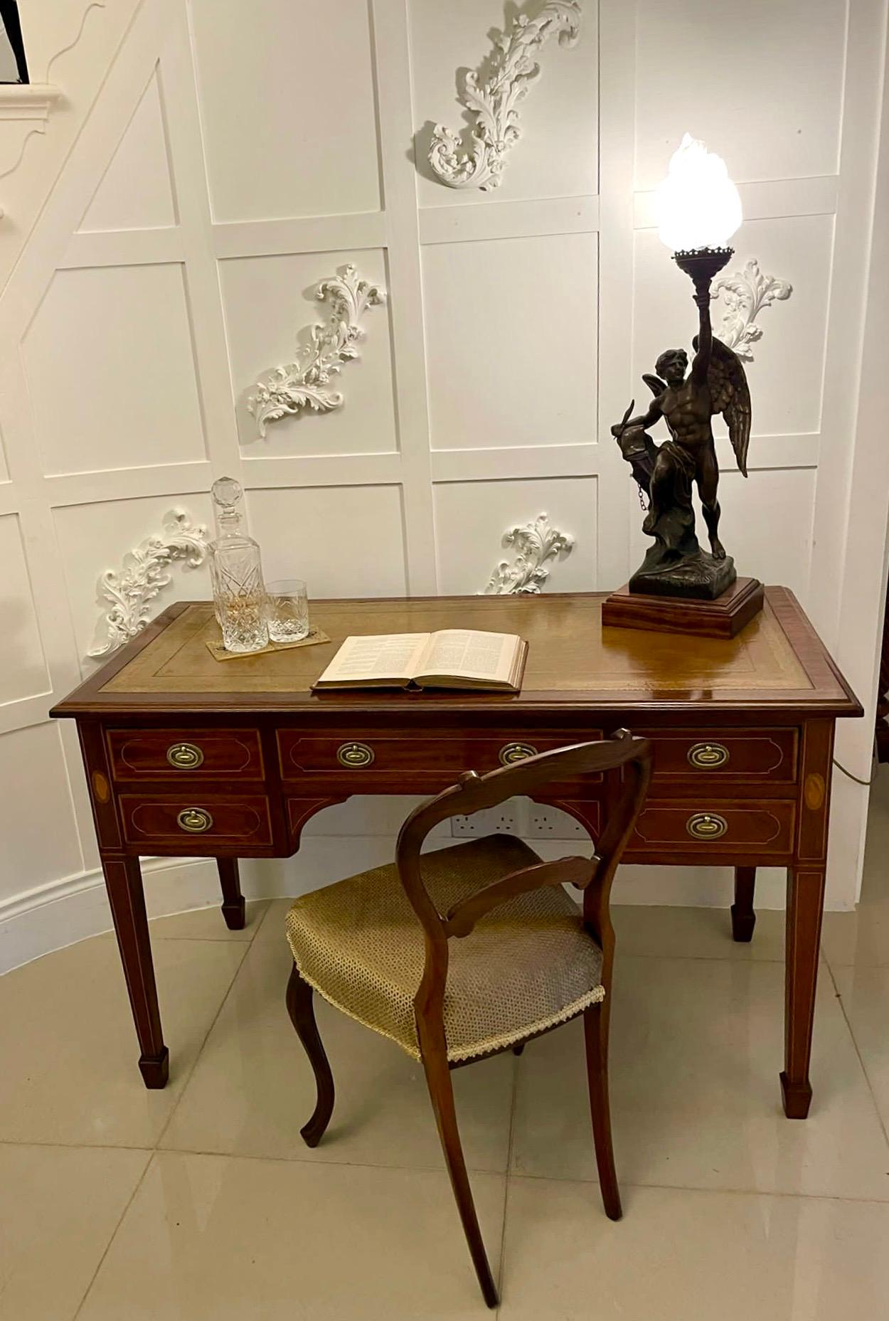 Antique Victorian quality mahogany inlaid writing desk having a quality mahogany rectangular shaped top with a moulded edge and a leather writing surface above five figured mahogany satinwood crossbanded drawers with original oval ornate brass