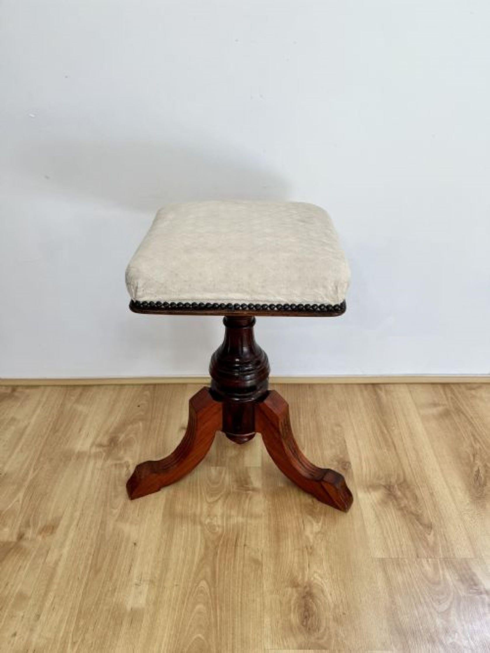 Antique Victorian quality mahogany revolving piano stool having a square shaped upholstered revolving seat supported by a quality mahogany turned pedestal column standing on shaped reeded cabriole legs.