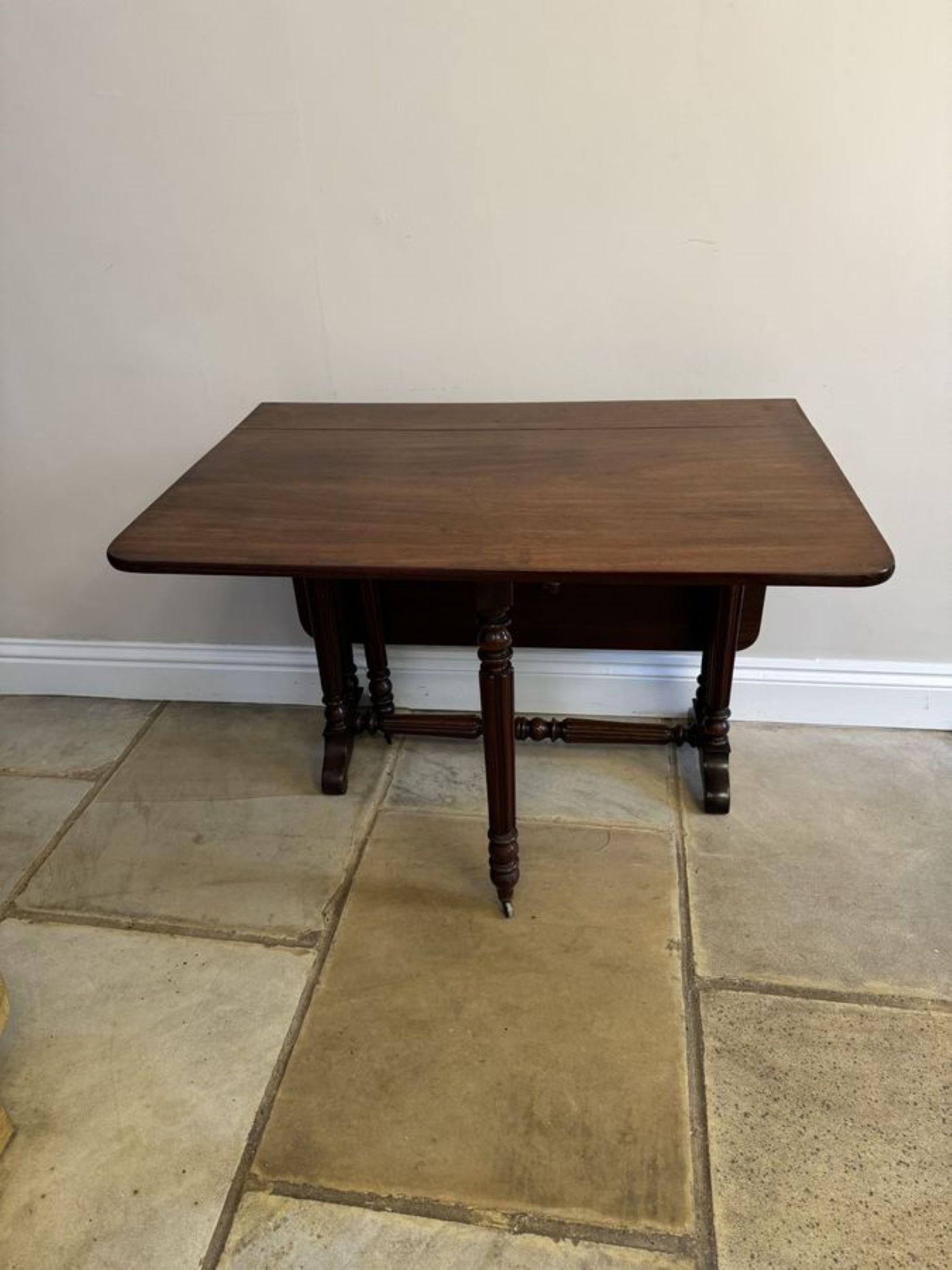Antique Victorian quality mahogany Sutherland table, having a quality mahogany top with two drop leaves supported by reeded columns, having two swing out legs with original castors standing on cabriole legs united by a reeded stretcher.

Dimensions