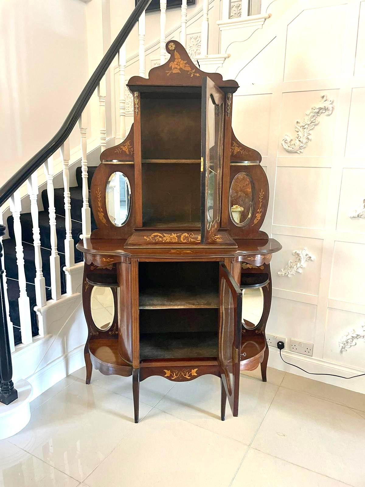 Antique Victorian quality marquetry inlaid mahogany display cabinet having a quality floral marquetry inlaid top with oval bevelled edge mirrors, ormolu mounts, glazed shaped door opening to reveal a fitted display shelf above an open ended display