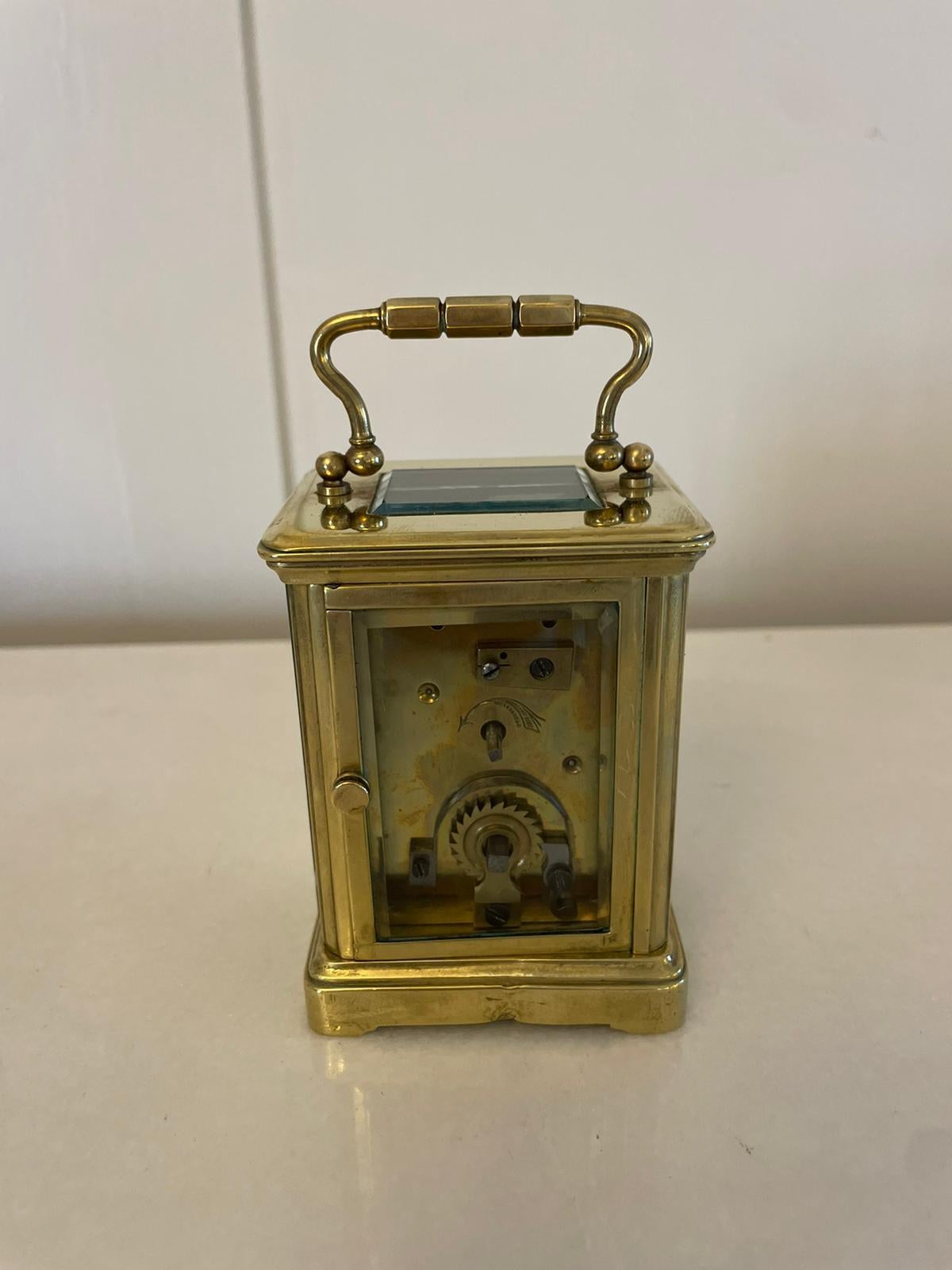 Antique Victorian quality miniature brass carriage clock having a quality brass carriage clock with bevelled edge, glass panels, white enamel dial with Roman numerals, original hands, 8 day movement and shaped carrying handle to the top