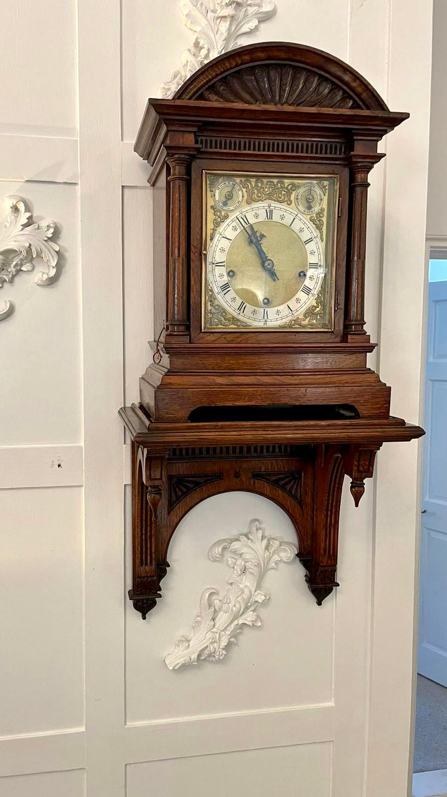 Antique Victorian quality oak 8 day chiming bracket clock with original bracket having a quality carved oak bracket clock with original carved oak bracket, ornate brass dial with original hands, silvered chapter ring with Roman numerals, 8 day