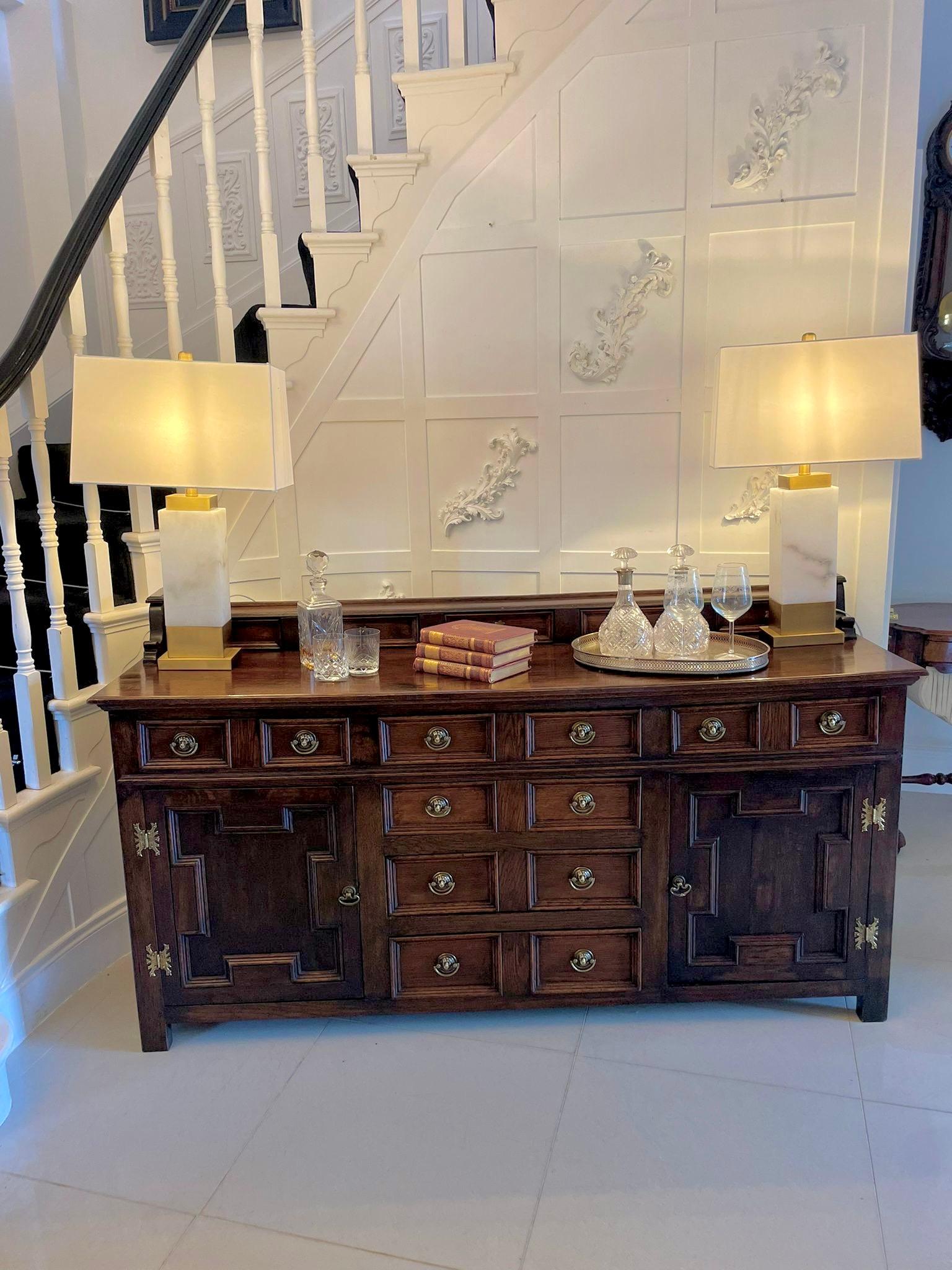 Antique Victorian quality oak dresser base having a small gallery back with 5 drawers, original brass handles above a quality oak top with a moulded edge above 6 moulded drawers with fabulous original lions head handles, 2 cupboard doors with
