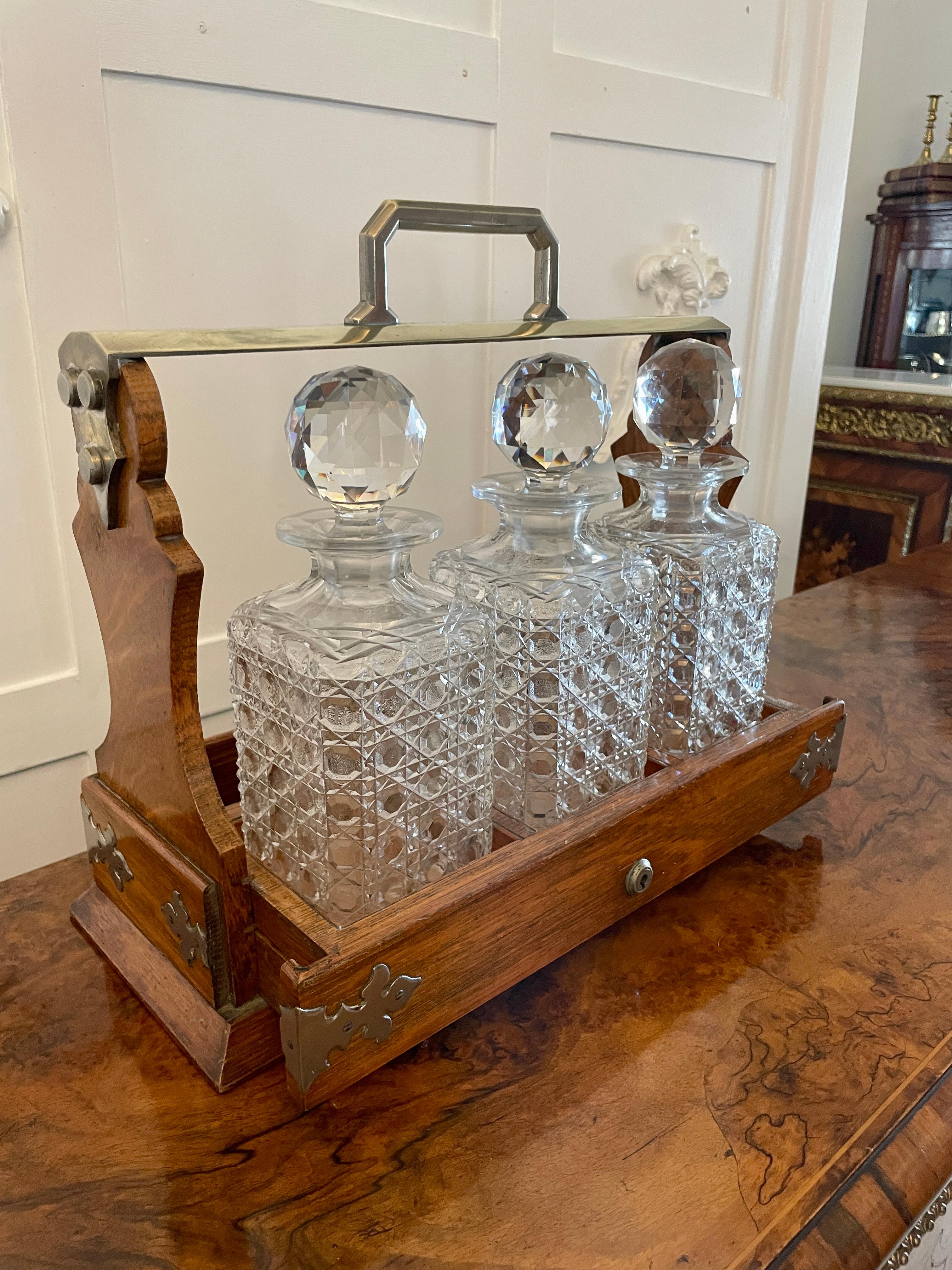 Antique Victorian quality oak tantalus by Mappin & Webb having a quality oak tantalus with a brass handle, unusual sliding base with three cut glass decanters and original stoppers 


A lovely example stamped with ‘The Cabinet’ 17 June