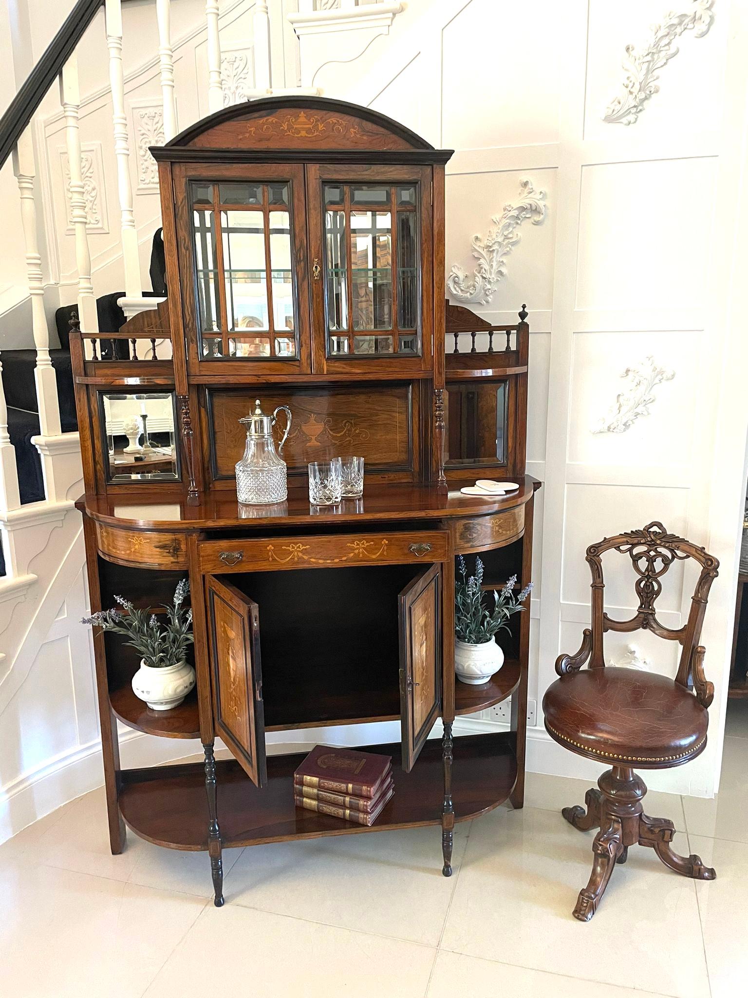 Antique Victorian quality rosewood inlaid side cabinet having a quality rosewood inlaid shaped pediment above a pair of astral bevelled edge glazed doors opening to reveal two glass display shelves. This attractive cabinet boasts a lovely marquetry
