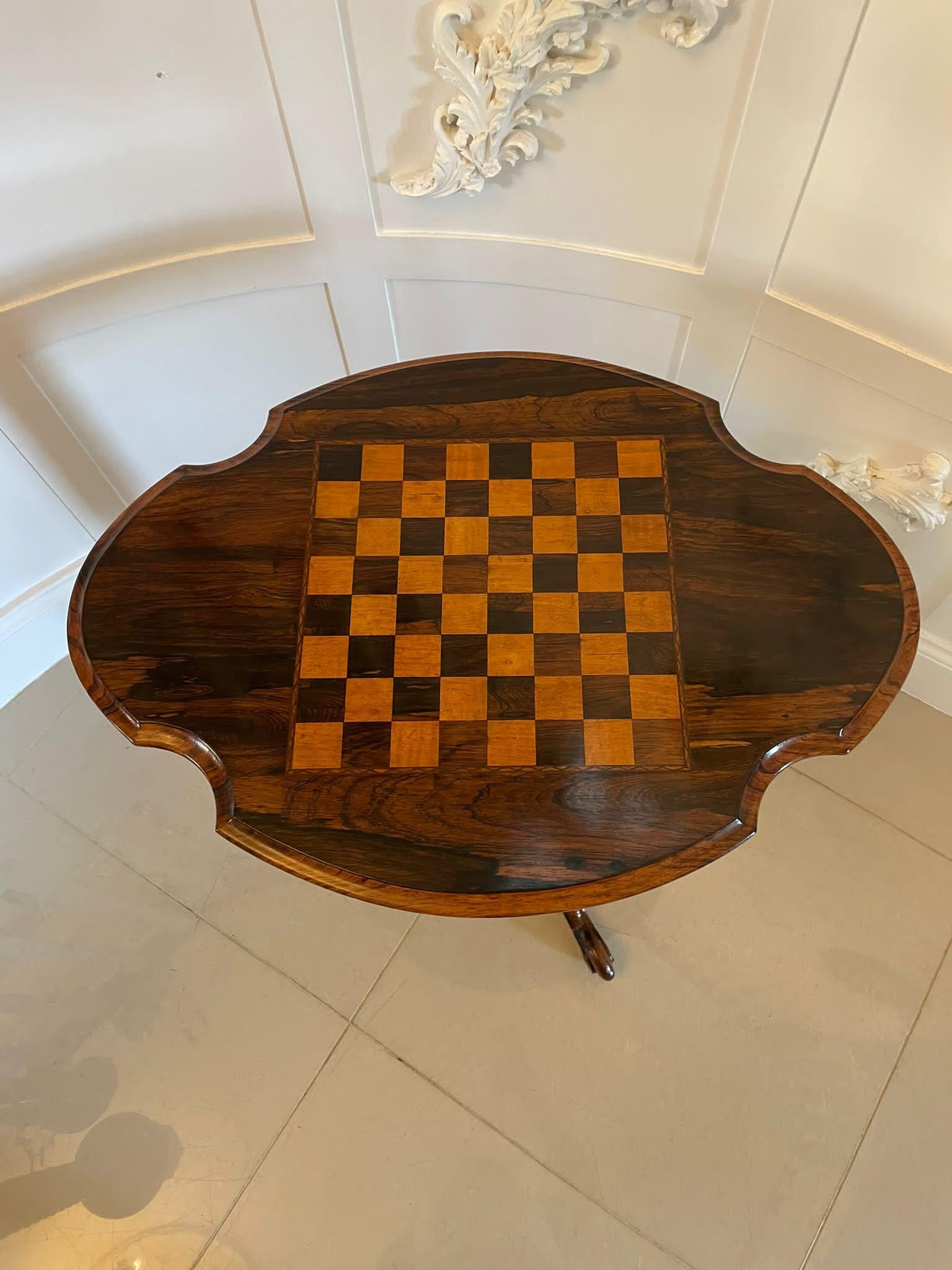 Antique Victorian quality rosewood games table having a quality shaped rosewood top with a thumb moulded edge and a inlaid chess board to the centre supported by a turned shaped carved column standing on three shaped carved cabriole legs with scroll