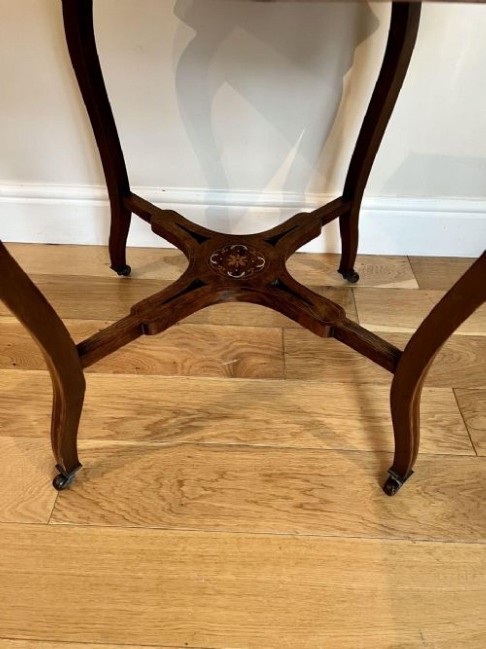 Antique Victorian quality rosewood inlaid centre table having a quality rosewood inlaid shaped top with a moulded edge, shaped rosewood inlaid frieze, standing on shaped cabriole legs with the original casters united by a cross stretcher with an