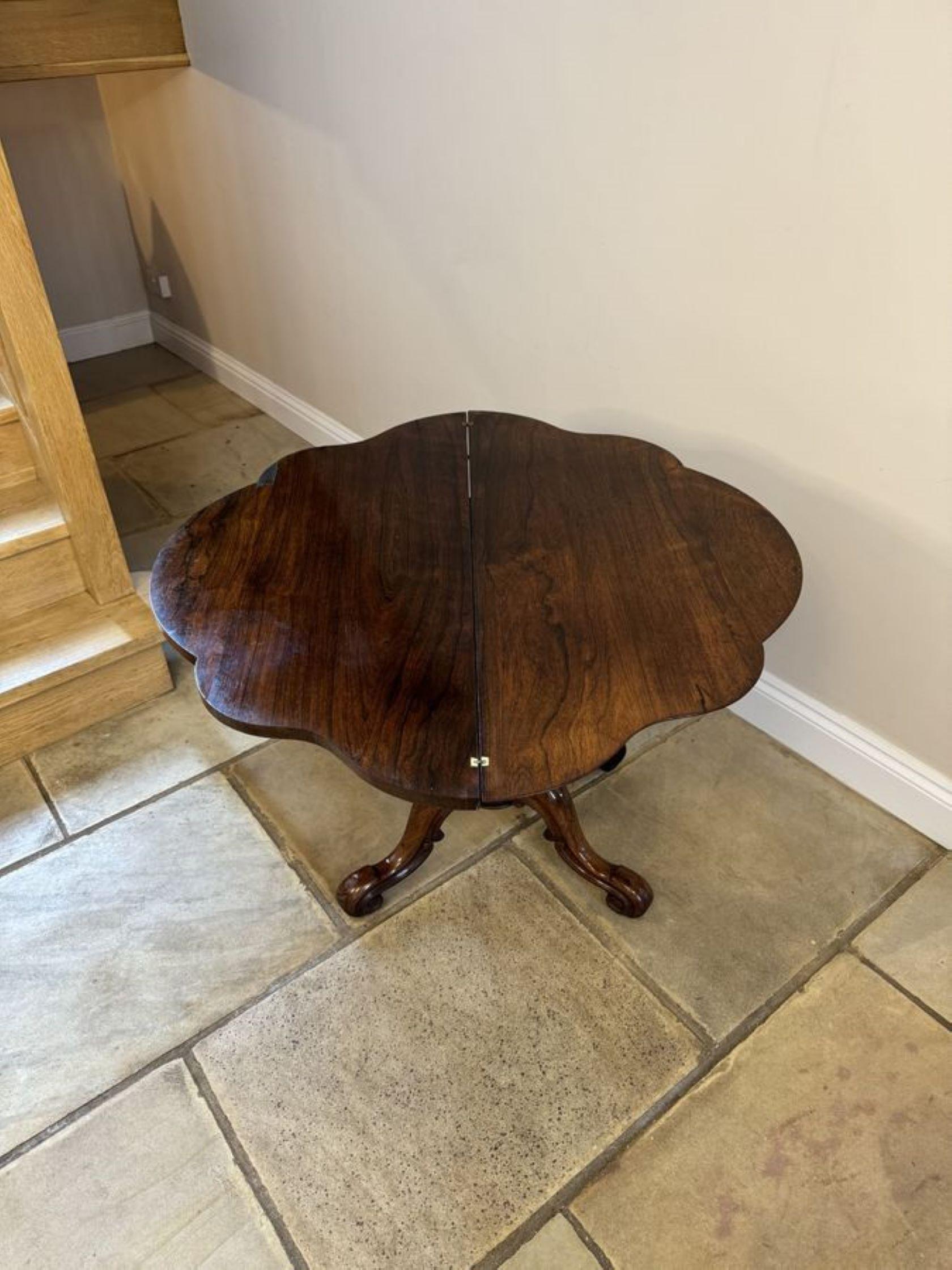 Antique Victorian quality rosewood tea table, having a quality rosewood serpentine shaped fold over top with a moulded edge opening to reveal a polished inside, supported by a turned carved pedestal column standing on shaped cabriole legs with