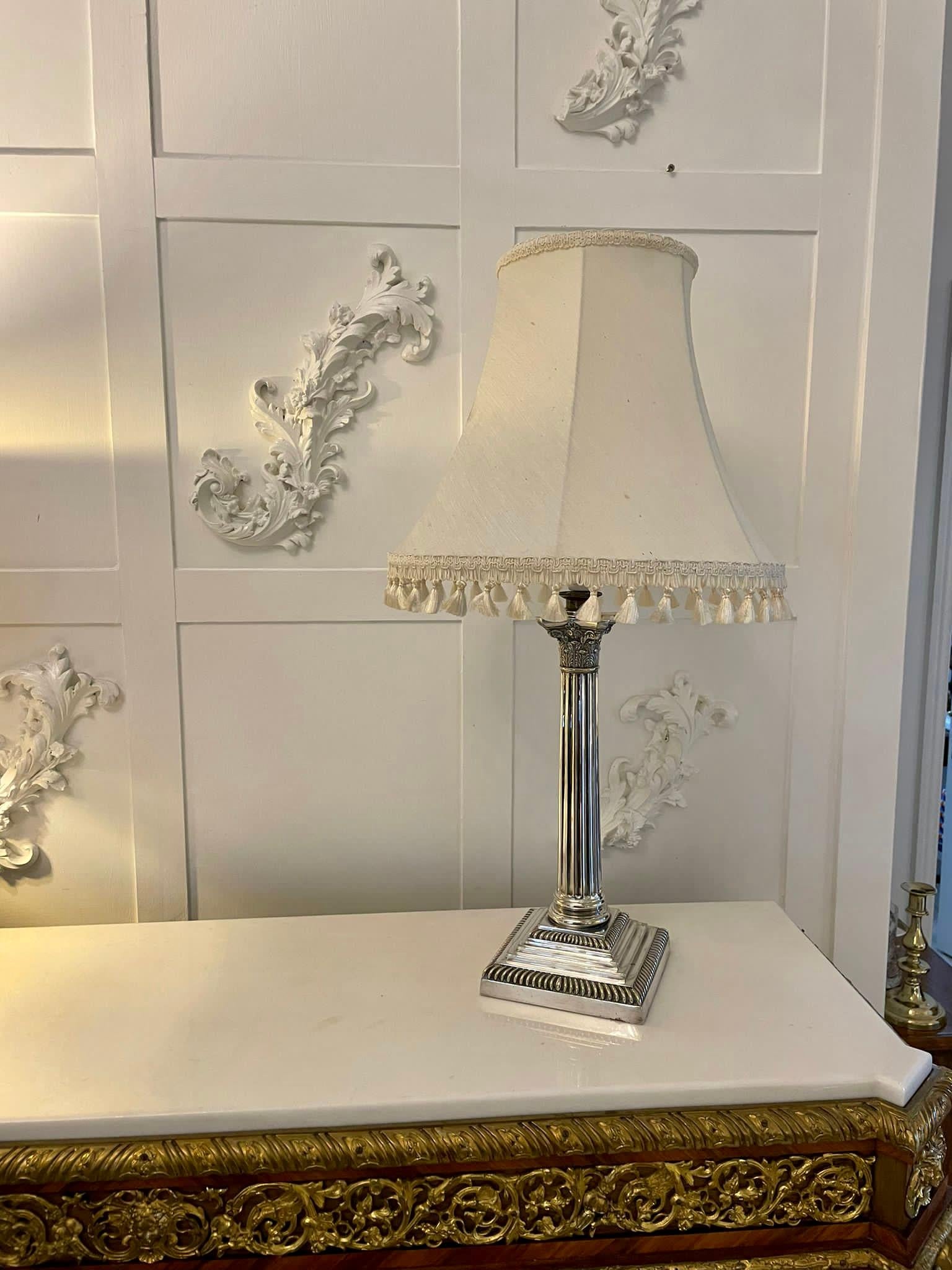Antique Victorian quality silver plated table lamp having a quality antique Victorian silver plated table lamp with a Corinthian column standing on a square stepped base. 

An attractive lamp in good working order. Shade not included.

Measures: