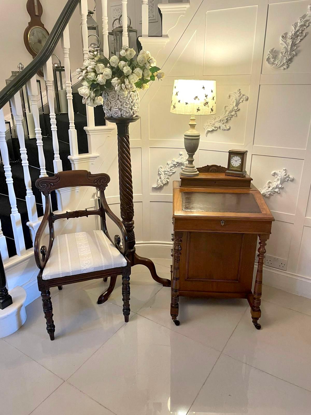 Antique Victorian quality walnut freestanding davenport having a lift up top opening to reveal a fitted interior above a lift up lid with a leather writing surface opening to reveal a fitted interior of drawers and storage compartment, four opening