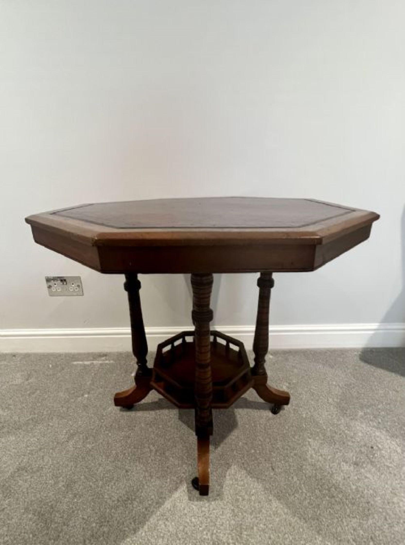 Antique Victorian quality walnut & leather top library table having a quality hexagonal shaped walnut and leather top supported on four turned columns, standing on four shaped cabriole legs with original casters united by a shaped under tier with a