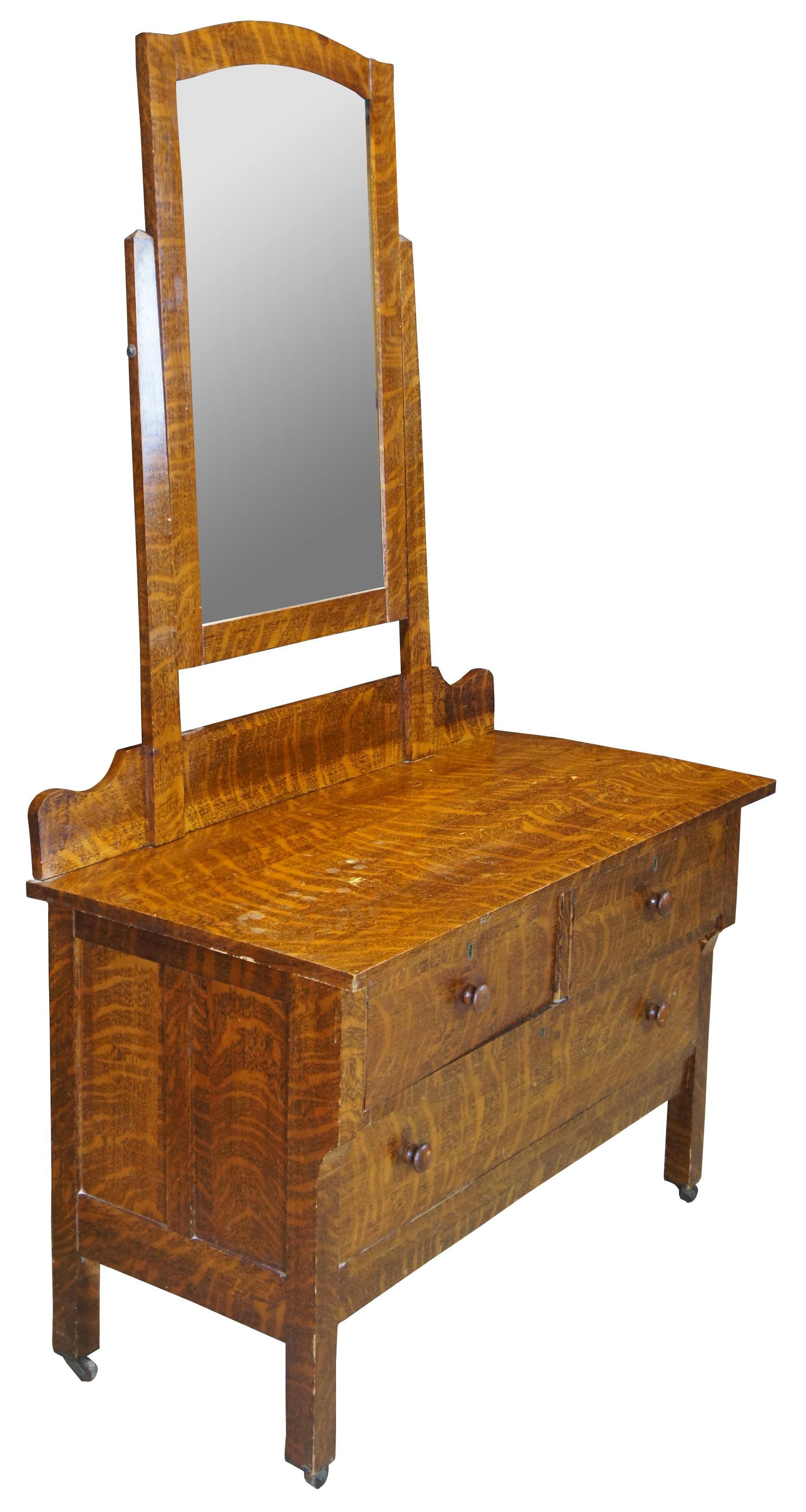 Circa 1880s quartersawn oak dresser with adjustable mirror. Features 3 drawers with pin and cove/knapp joint construction. 

The Knapp joint was developed during the late Victoria Era in post Civil War United States. Patented by Charles Knapp of