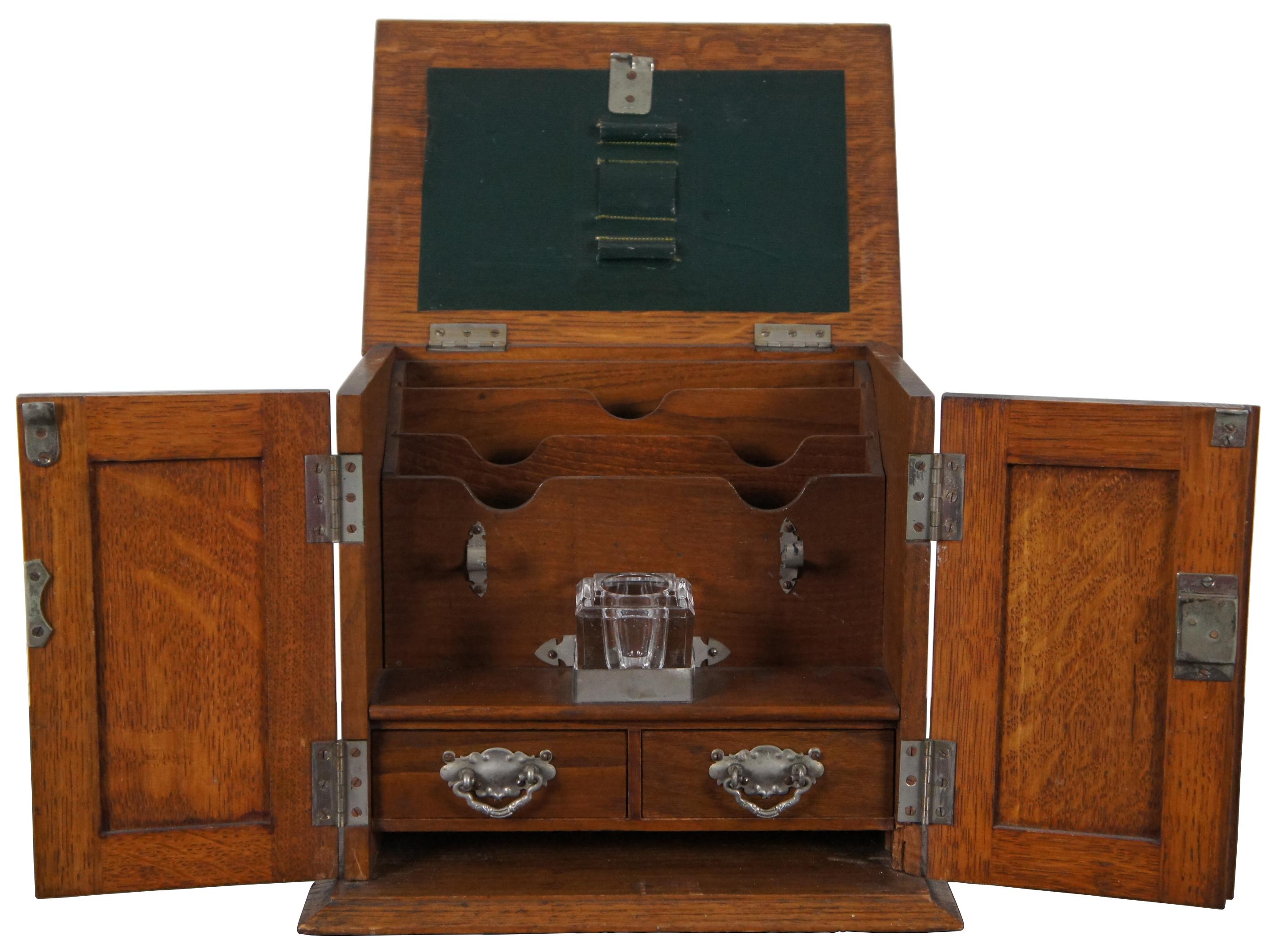 Antique quartersawn oak library desk top stationary cabinet with envelope slots, two small drawers, several pen rests/slots and glass ink well.