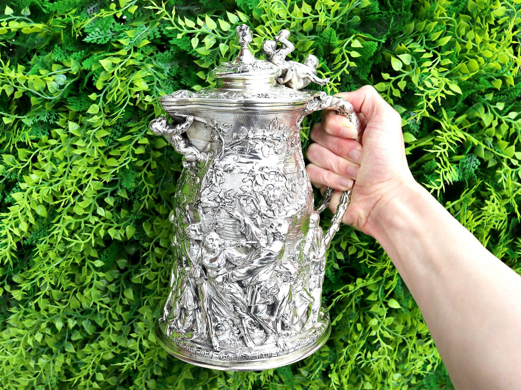 A magnificent, fine and impressive antique Victorian sterling silver jug with royal interest; part of our antique silver jugs and dining collections.

This magnificent antique Victorian sterling silver covered beer jug has a circular shaped