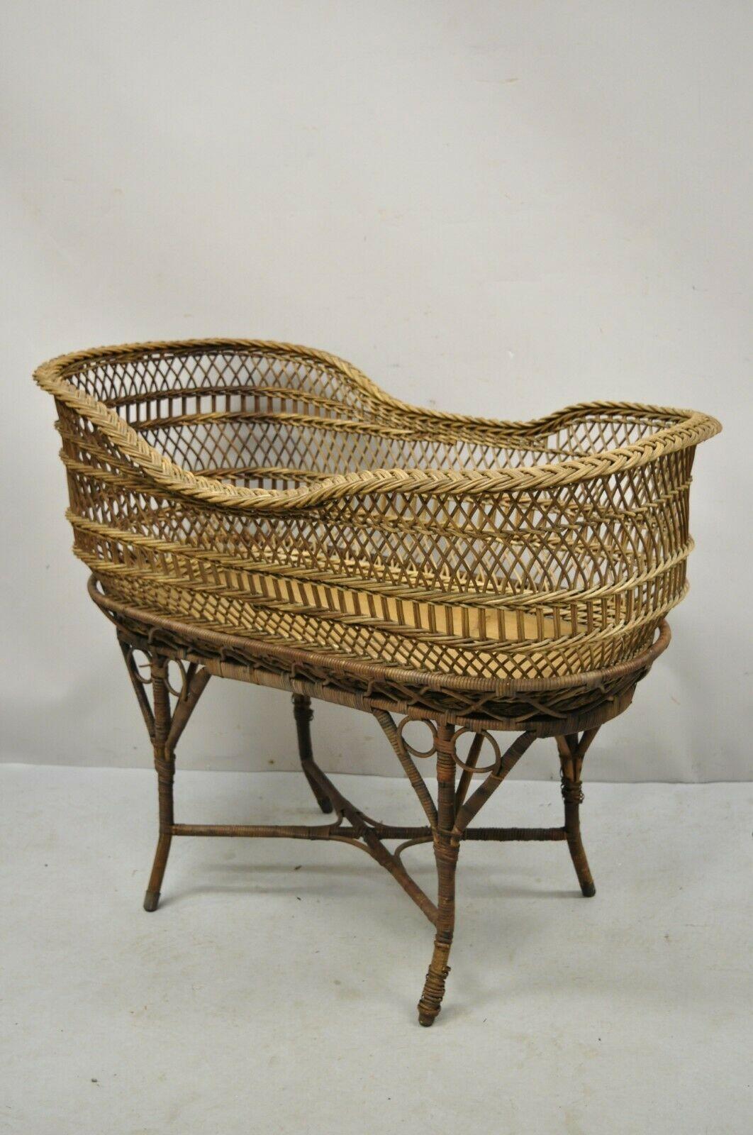 Antique Victorian Rattan and Wicker Baby Bassinet Cradle. Item features solid wood frame, very nice antique item, rattan wrapped base, removable wicker bassinet, stretcher base, canopy frame (not attached), solid wood frame, very nice antique item.