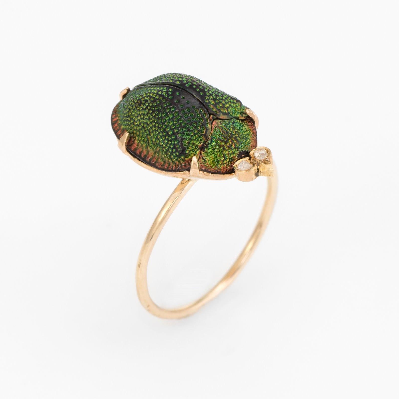 Originally an antique Victorian era stick pin (circa 1880s to 1900s), the scarab beetle ring  is crafted in 10 karat yellow gold.

The ring is mounted with the original stick pin. Our jeweler rounded the stick pin into a slim band for the finger.
