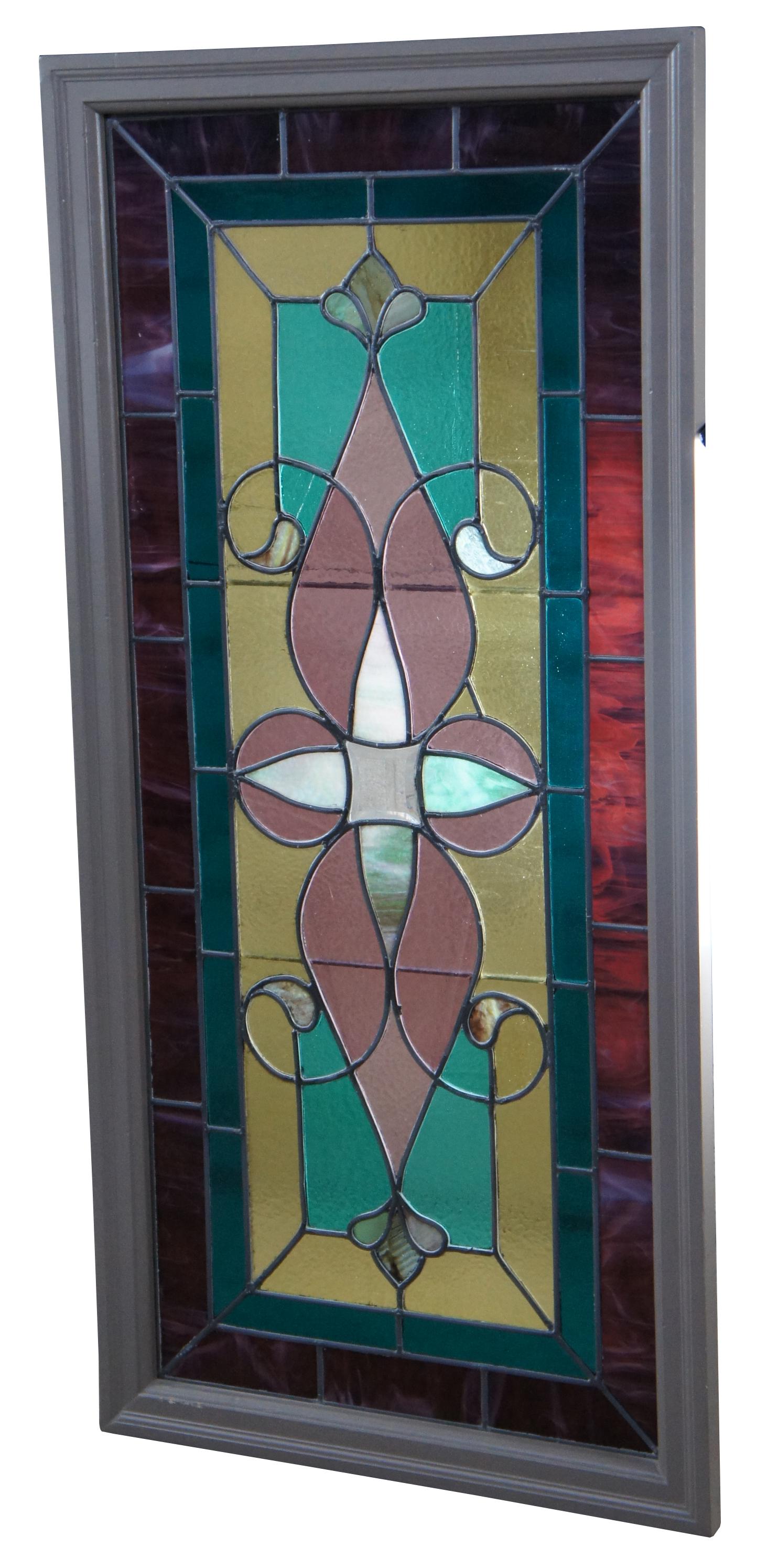 Beautiful antique Victorian leaded stained glass window panel. A geometric blend of amber, purple, greens and pink. Framed in gray and ready to hang.  Measure: 50