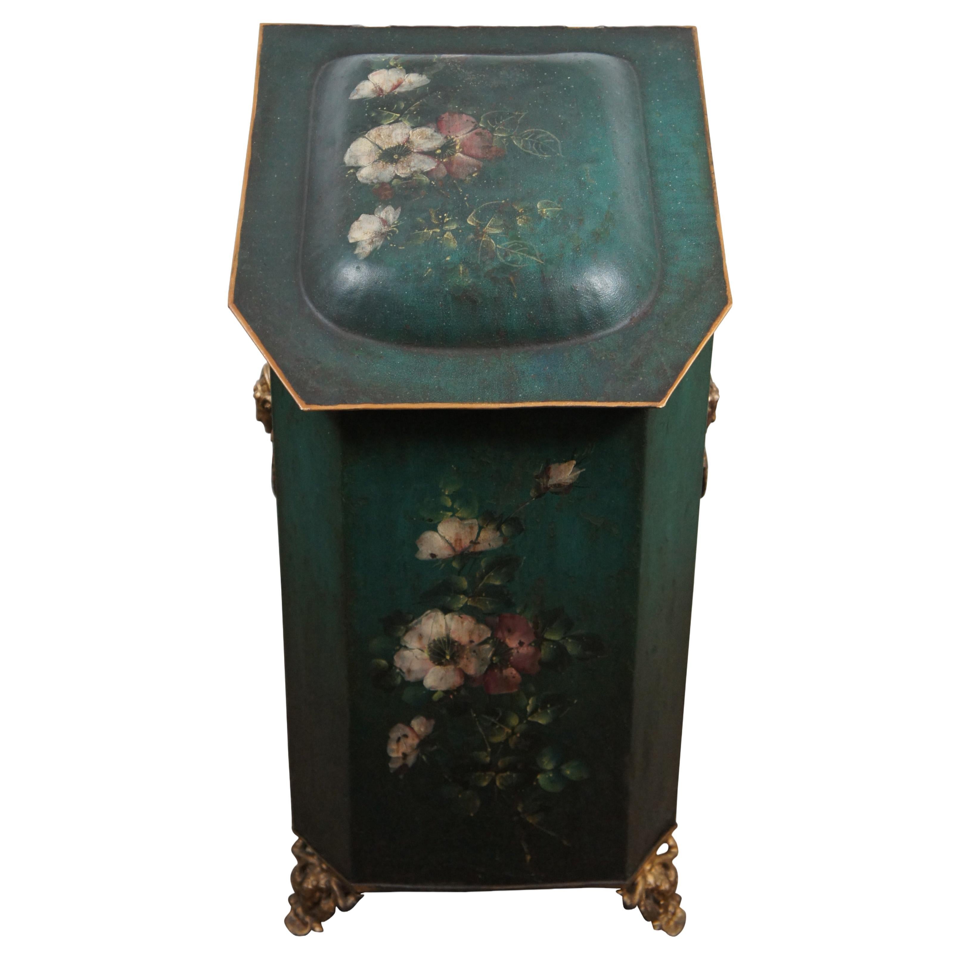 An impressive antique Victorian Renaissance revival coal hod / bin or scuttle, circa 1870s.  Made of metal / tin with hinged lid featuring lustrous green floral hand painted tole design.  Features ornate gold figural brass door knocker handles over