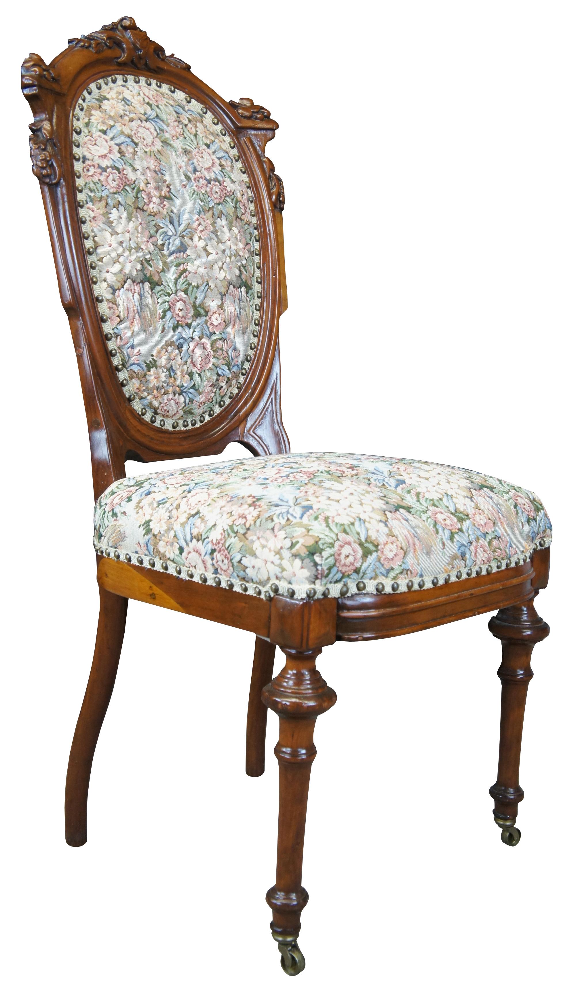 Antique Victorian Renaissance Revival walnut parlor / vanity / dining chair featuring ornate carvings, needlepoint upholstery, nailhead trim and front castors.
   