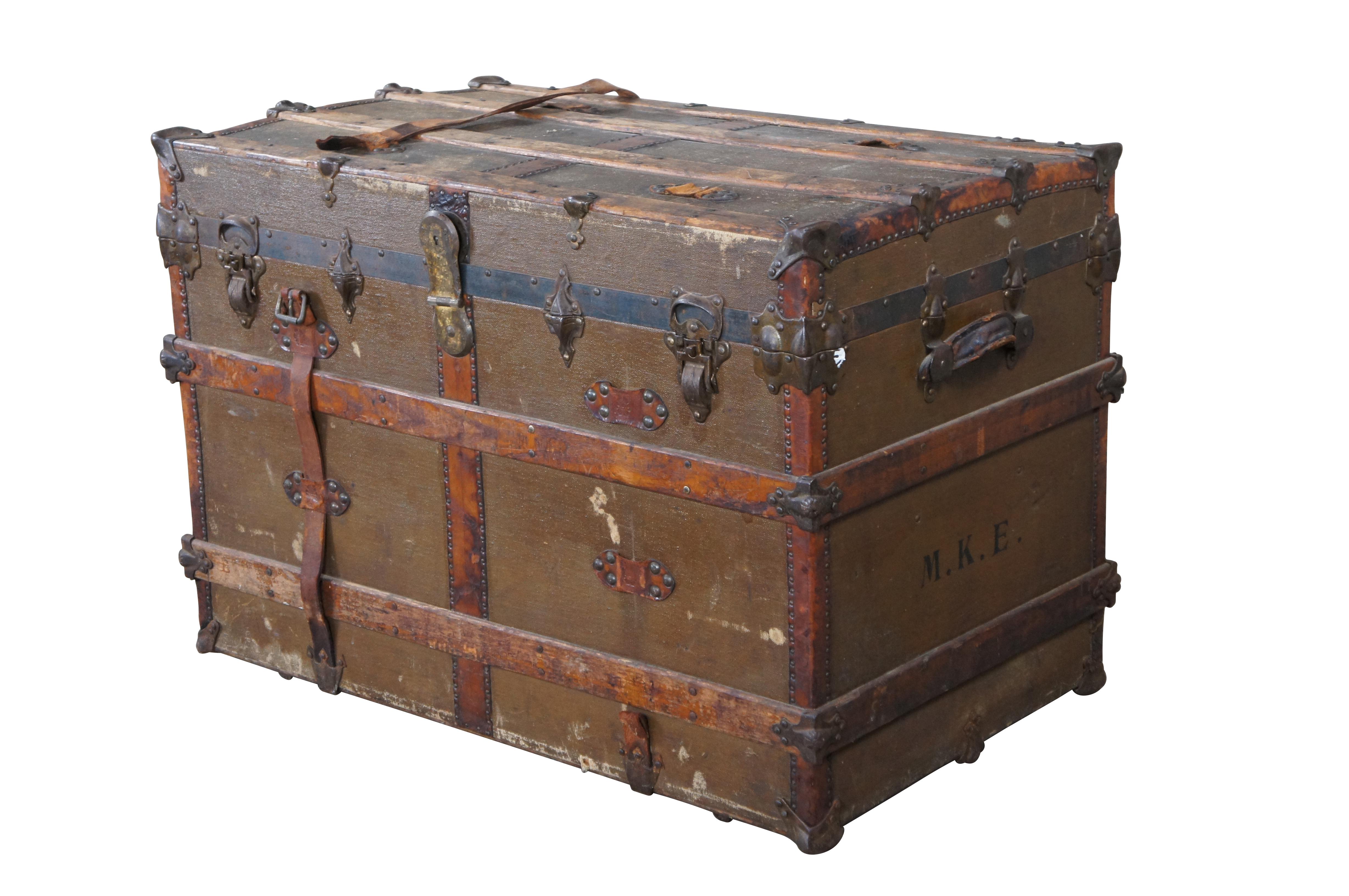 Victorian Era Flat Top Steamer Trunk or Chest by R&H Modern Trunks.  Made from wood with a canvas wrap, leather accents and brass hardware.  The side of the trunk is Monogrammed M.K.E.  The other side reads Emrick Dayton, Ohio.  Great for storage or
