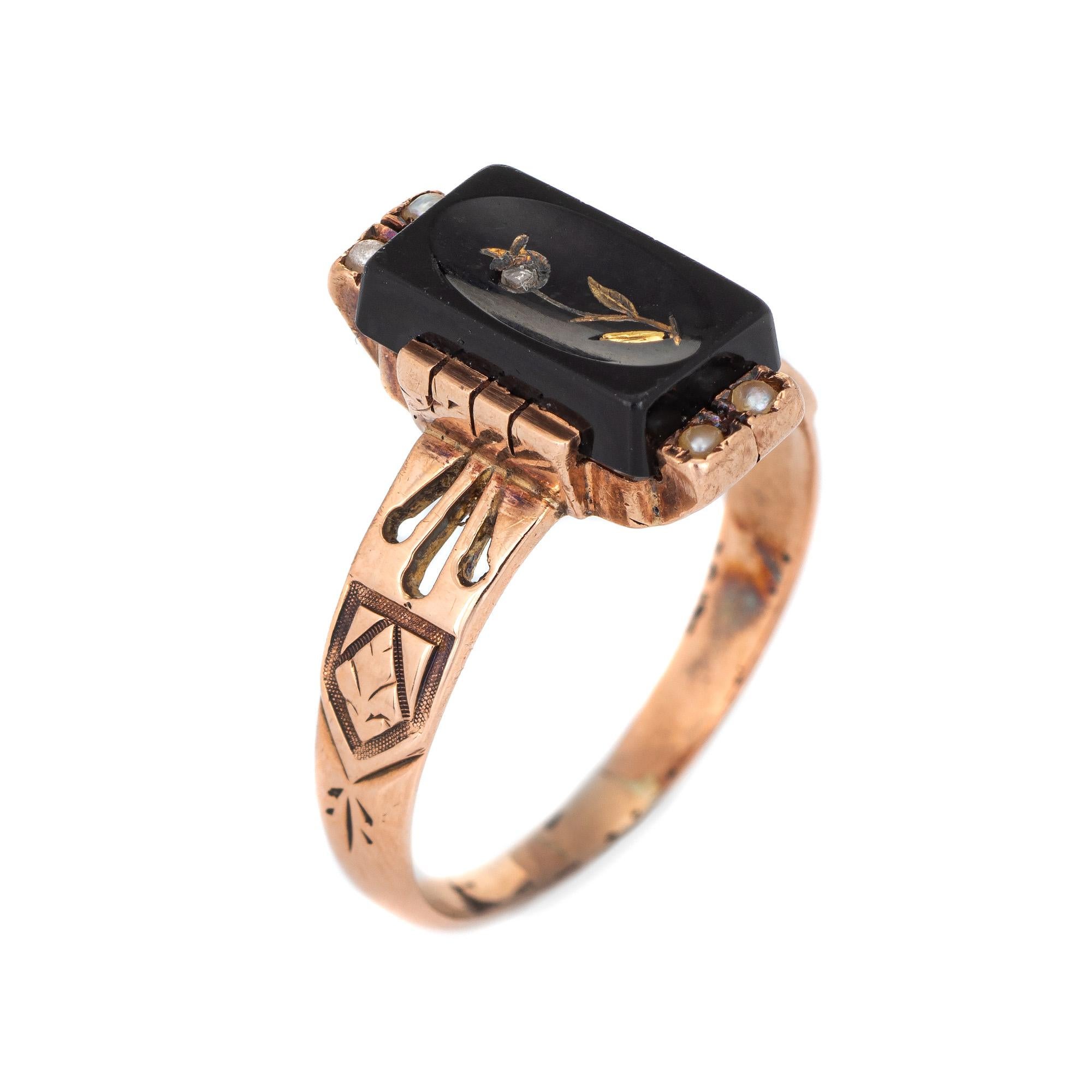 Finely detailed antique Victorian ring (circa 1880s to 1900s) crafted in 10 karat rose gold. 

One estimated 0.01 carat rose cut diamond is set into the mount with four 1mm seed pearls set into both ends of the onyx. The onyx measures 10mm x